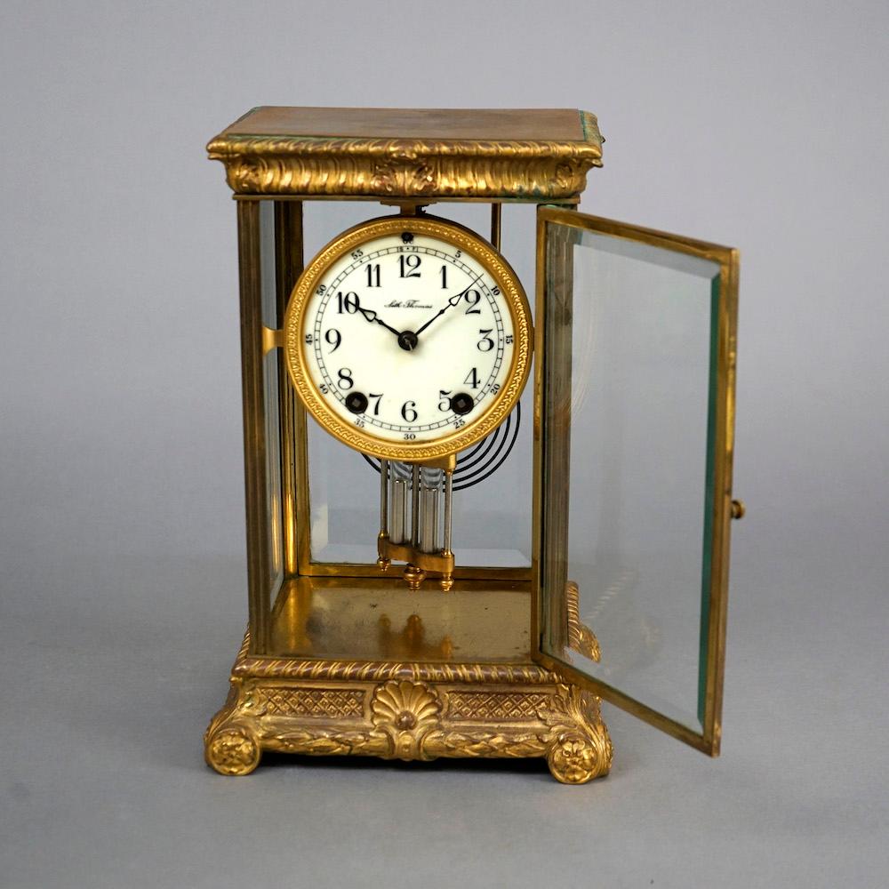 An antique crystal regulator mantle clock by Seth Thomas offers gilt bronze and crystal case with embossed foliate, shell and rosette design, with key, circa 1890

Measures- 11.75''H x 7.5''W x 6.25''D