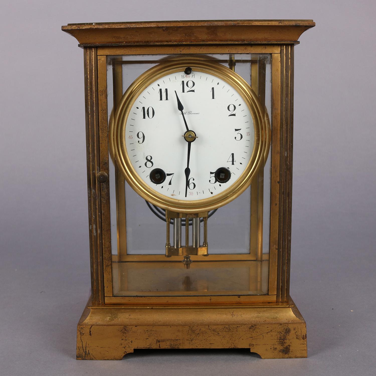 Antique crystal regulator mantle clock by Seth Thomas features gilt metal and bevelled crystal glass case with enameled face having Arabic numerals and signed Seth Thomas, in working order with key and chiming on the hour with count and half-hour,