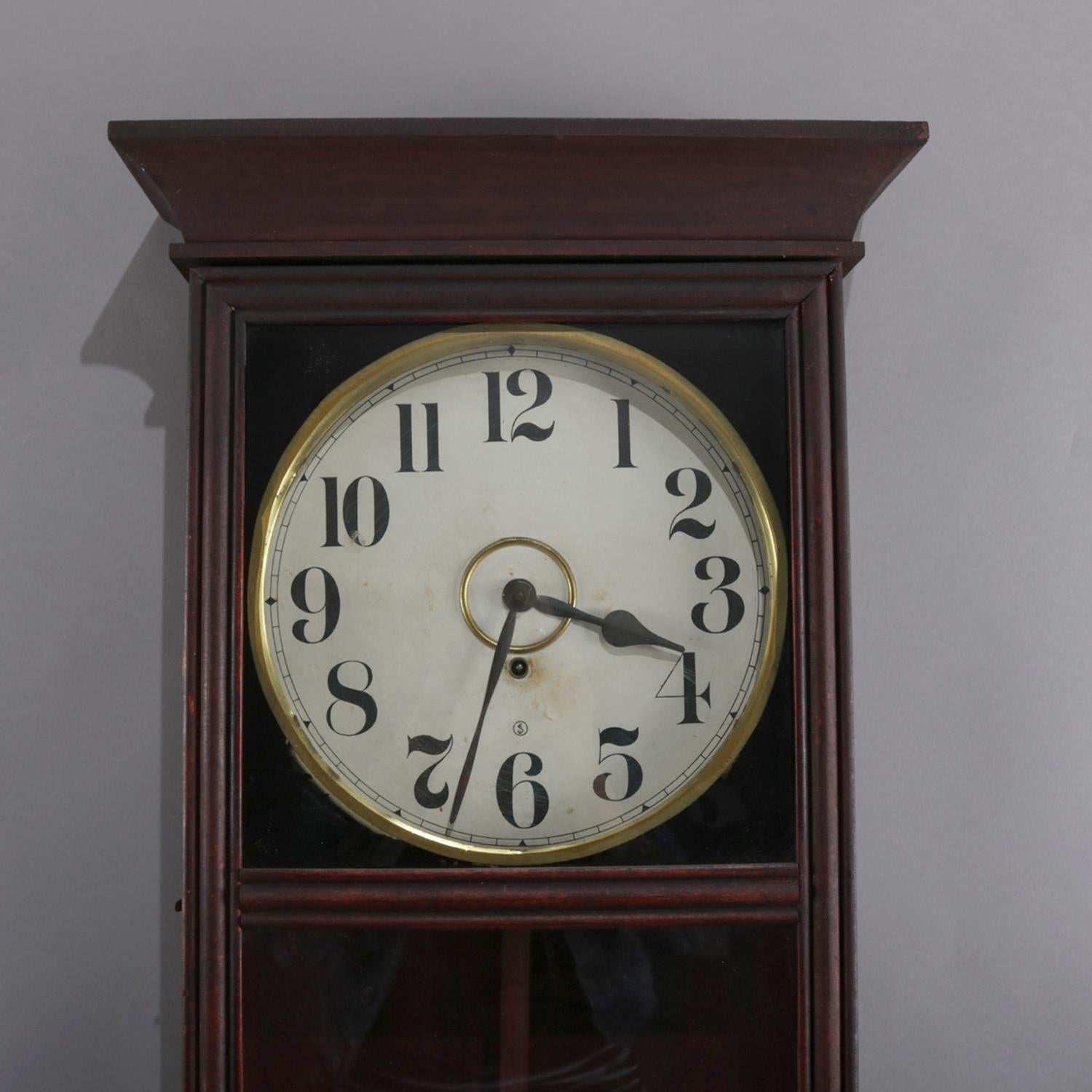 Antique Seth Thomas School University model regulator wall clock by Gilbert Clock Company features mahogany case and face by E & J Swiigart with Arabic numerals and signed ESJ, working and with key, circa 1913

Measures: 34.5