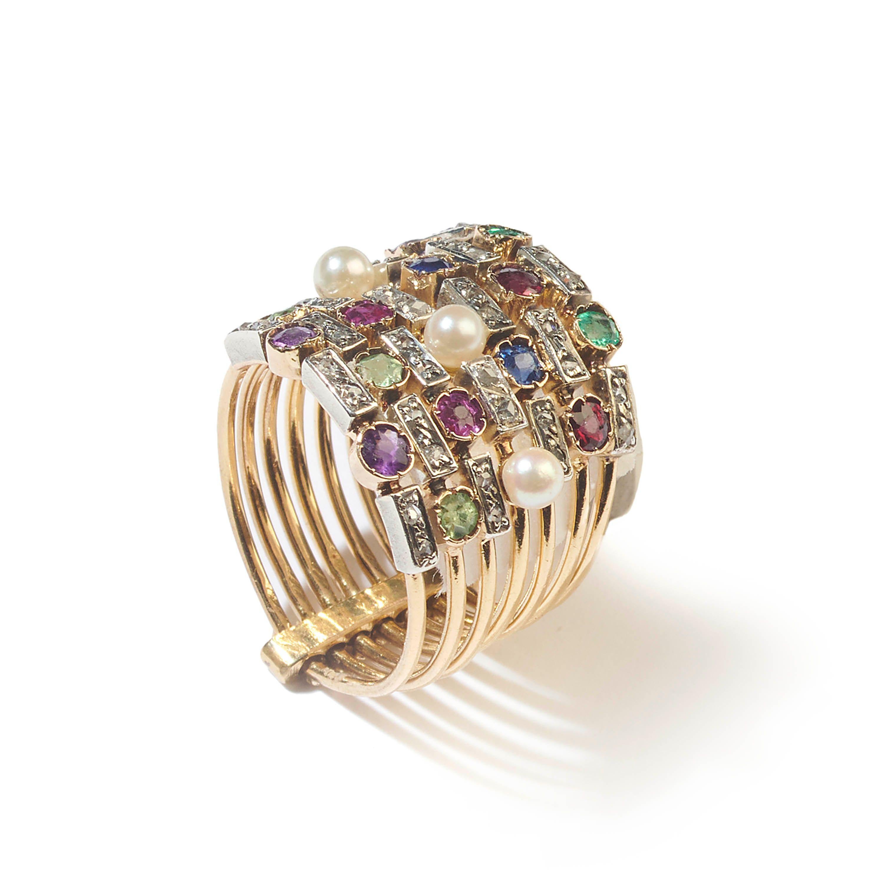 An antique gemstone seven row ring, set with amethyst, peridot, ruby, pearl, sapphire, garnet, emerald and diamond, with alternating sets of coloured gemstones, in collet spitch settings and pairs of grain set rose-cut diamonds, in rectangular