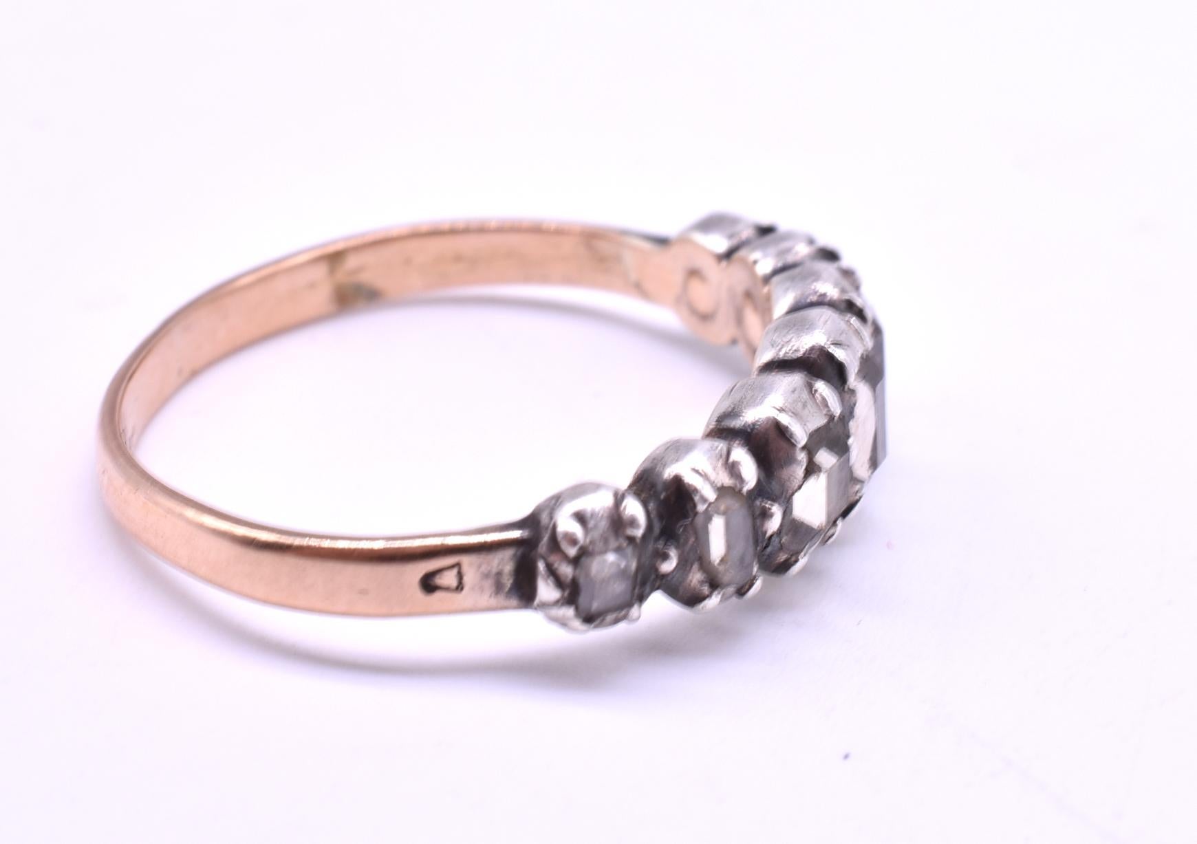 This early C1790 18K seven stone diamond half hoop ring has seven table-cut diamonds (flat on top, faceted on the sides). The ring is closed back and the diamonds are foiled backed, exactly the way gemstone rings were made in the Georgian period.