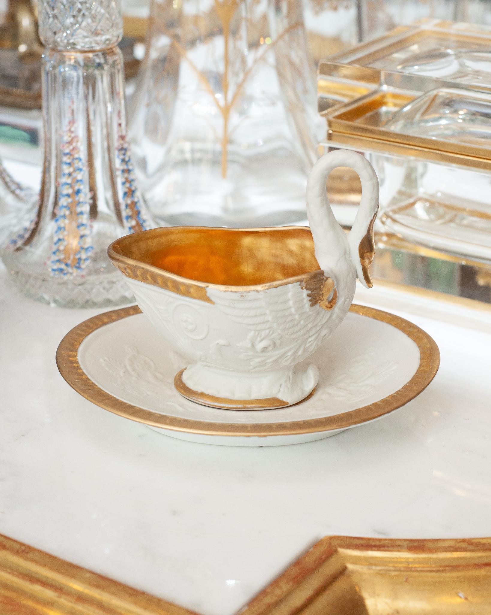 A beautiful antique Sèvres swan sauce boat in biscuit porcelain with gilded detail. This smaller scale sauce boat is a whimsical addition to the table and in great condition for it’s age. Minor wear to gilding and signature on underside.