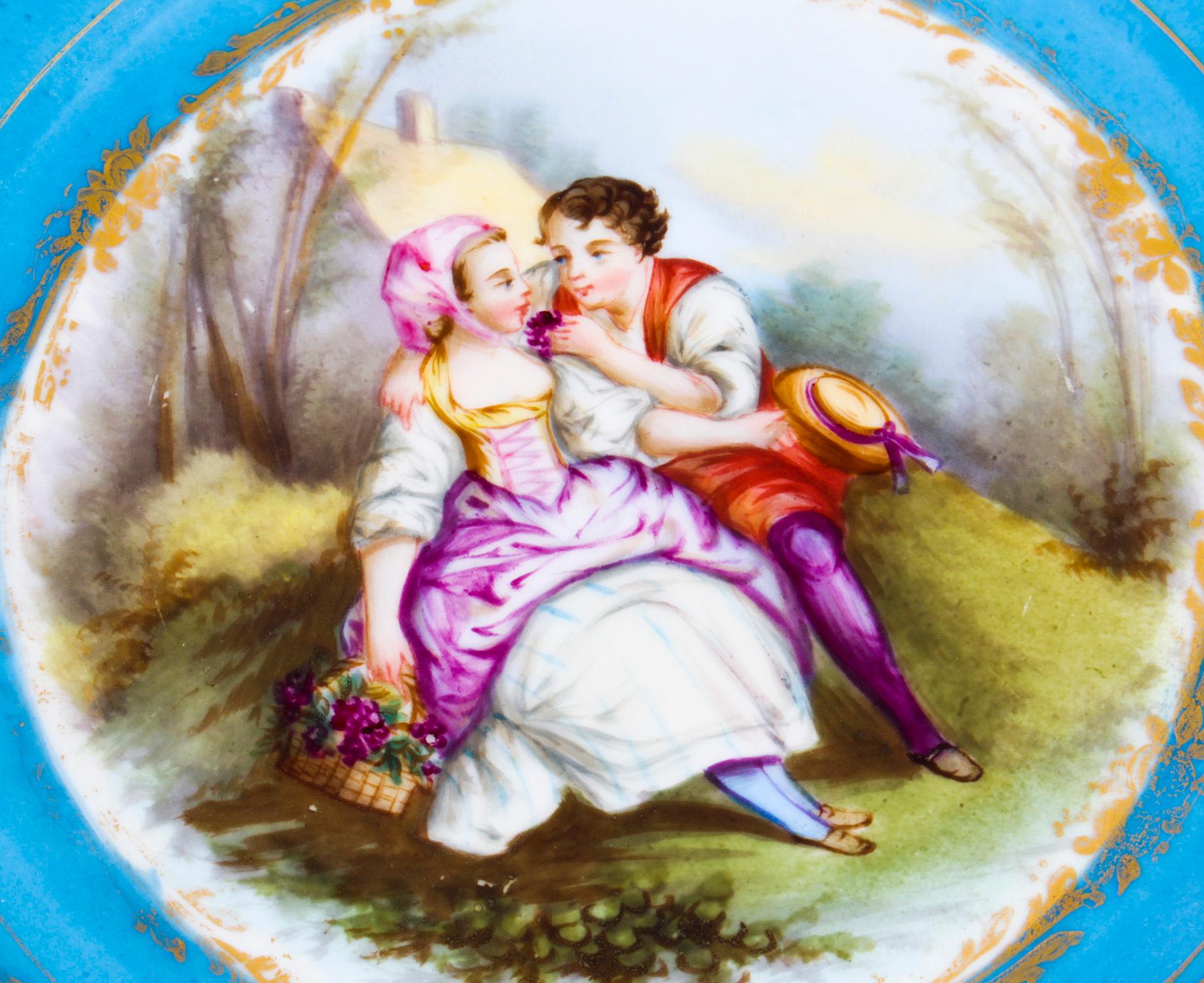 This is a fabulous decorative antique porcelain cabinet plate, with painted marks to the reverse and dating from Circa 1880.
 
It has striking Bleu Celeste and gilt tooled borders painted with a young courting couple on landscape to the centre and