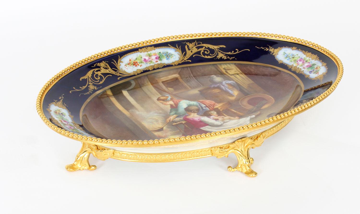 This is an important large decorative antique French ormolu mounted oval sevres porcelain dish, the rear with underglaze blue interlaced LL factory Sevres mark and bearing the signature of the artist, E. Collot, Circa 1880 in date.
 
It has a