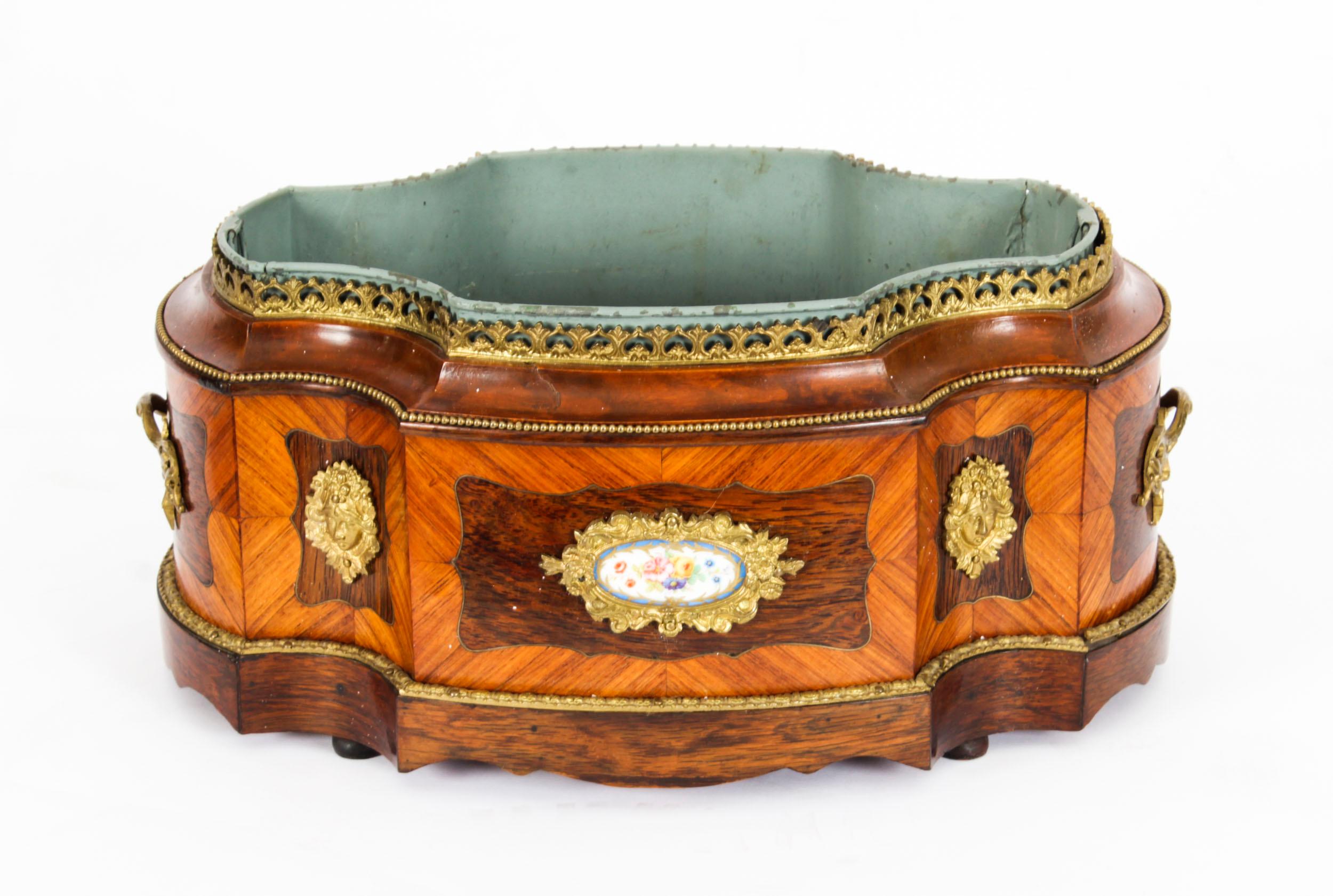 This is a superb antique French Louis XV revival ormolu and Sevres porcelain mounted, wood jardiniere, circa 1860 in date.
 
This beautiful planter has splendid ormolu mounts enclosing an enchanting hand-painted and gilded Sevres porcelain plaques