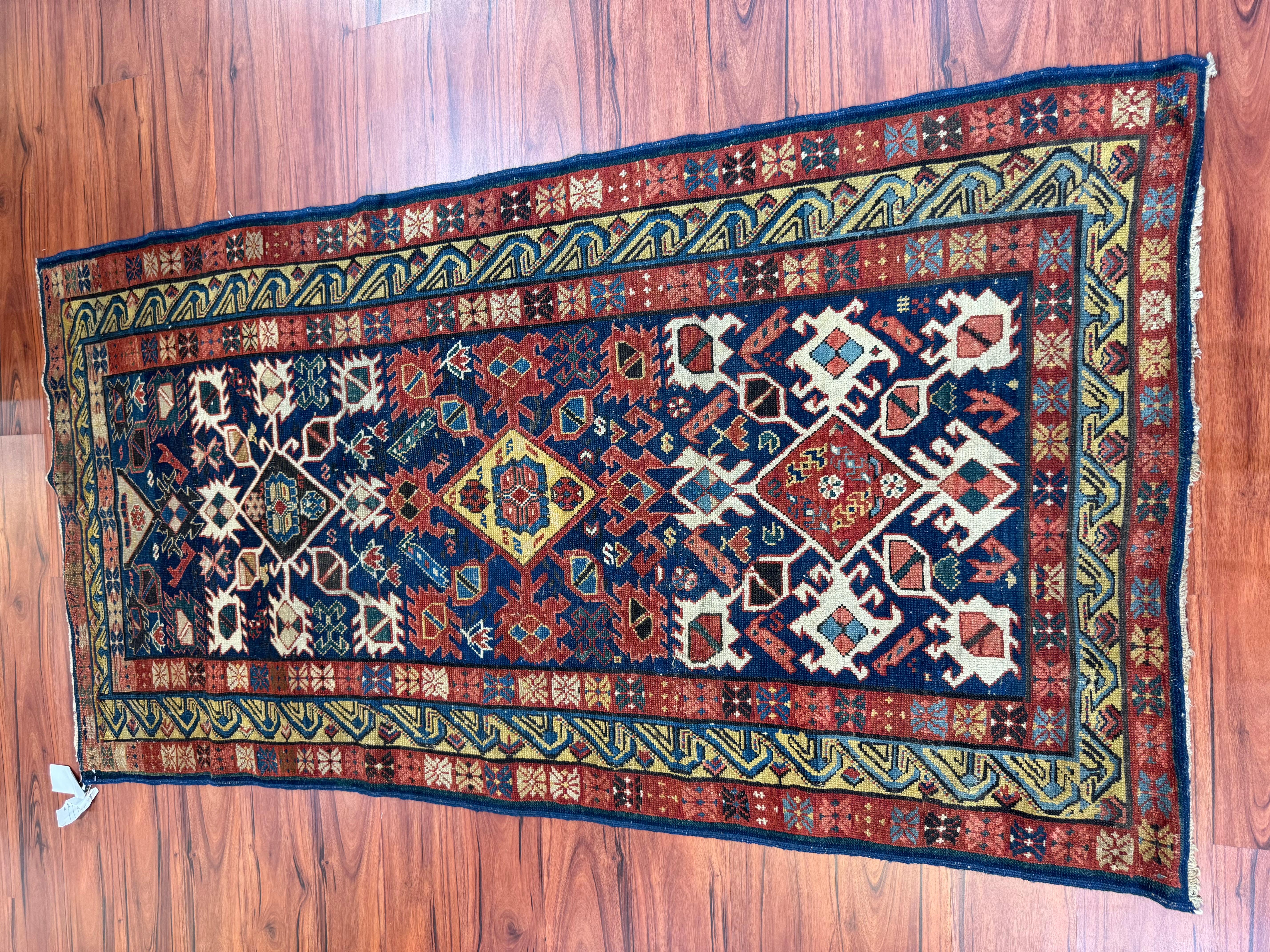 A stunning antique Seychour Caucasian rug that originates from Azerbaijan in the 19th century. This rug has a rich history and is in very good condition. Measurements are 3’5” by 6’4” ft. Feel free to message me about this listing or any other I