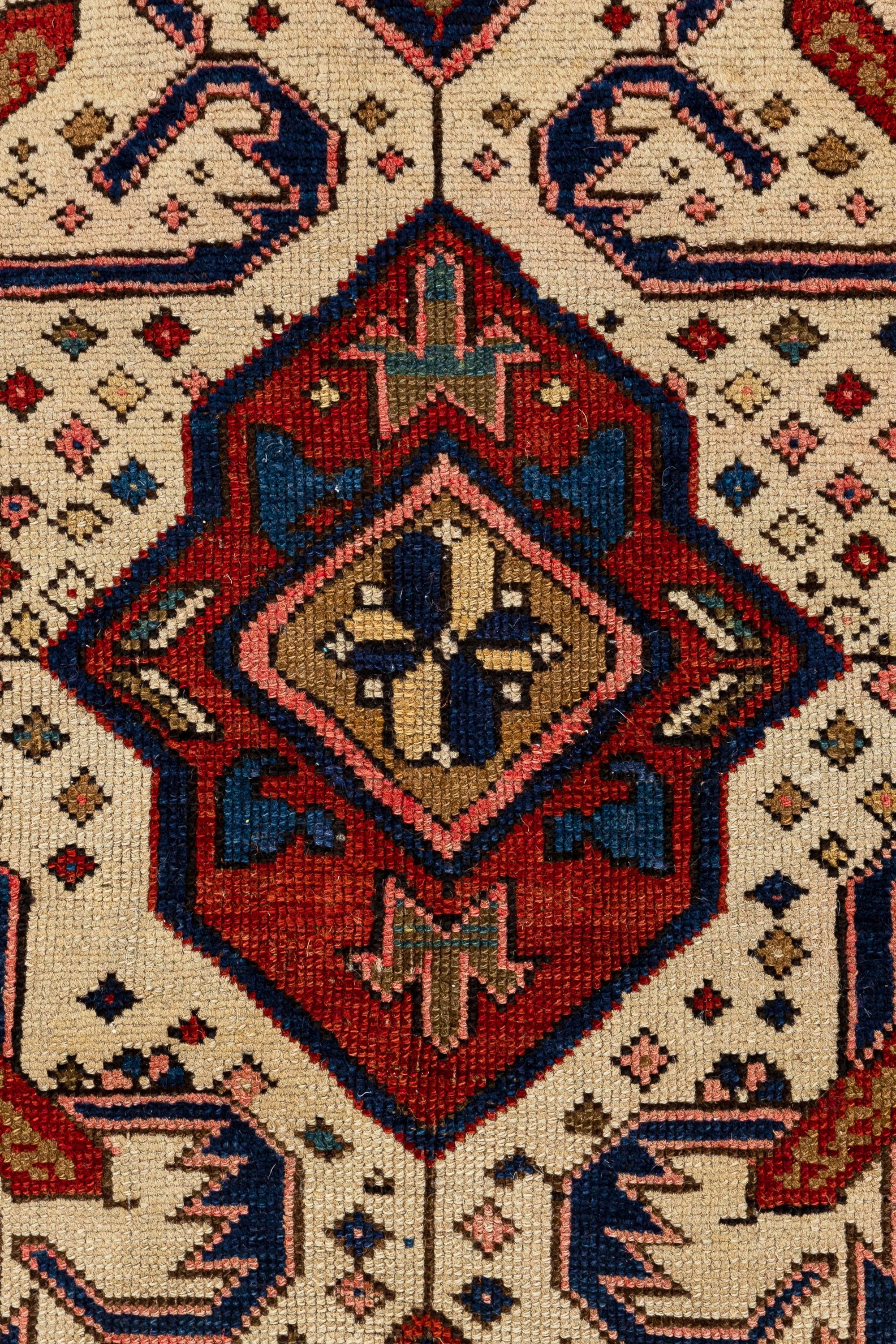 Seychour – Kuba, Northeast Caucasus

This elegant and distinct Seychour rug with an Alpan Crab design features an ivory field filled with geometric figures, including diamonds, flowers, and colourful animals arranged randomly and spontaneously. In
