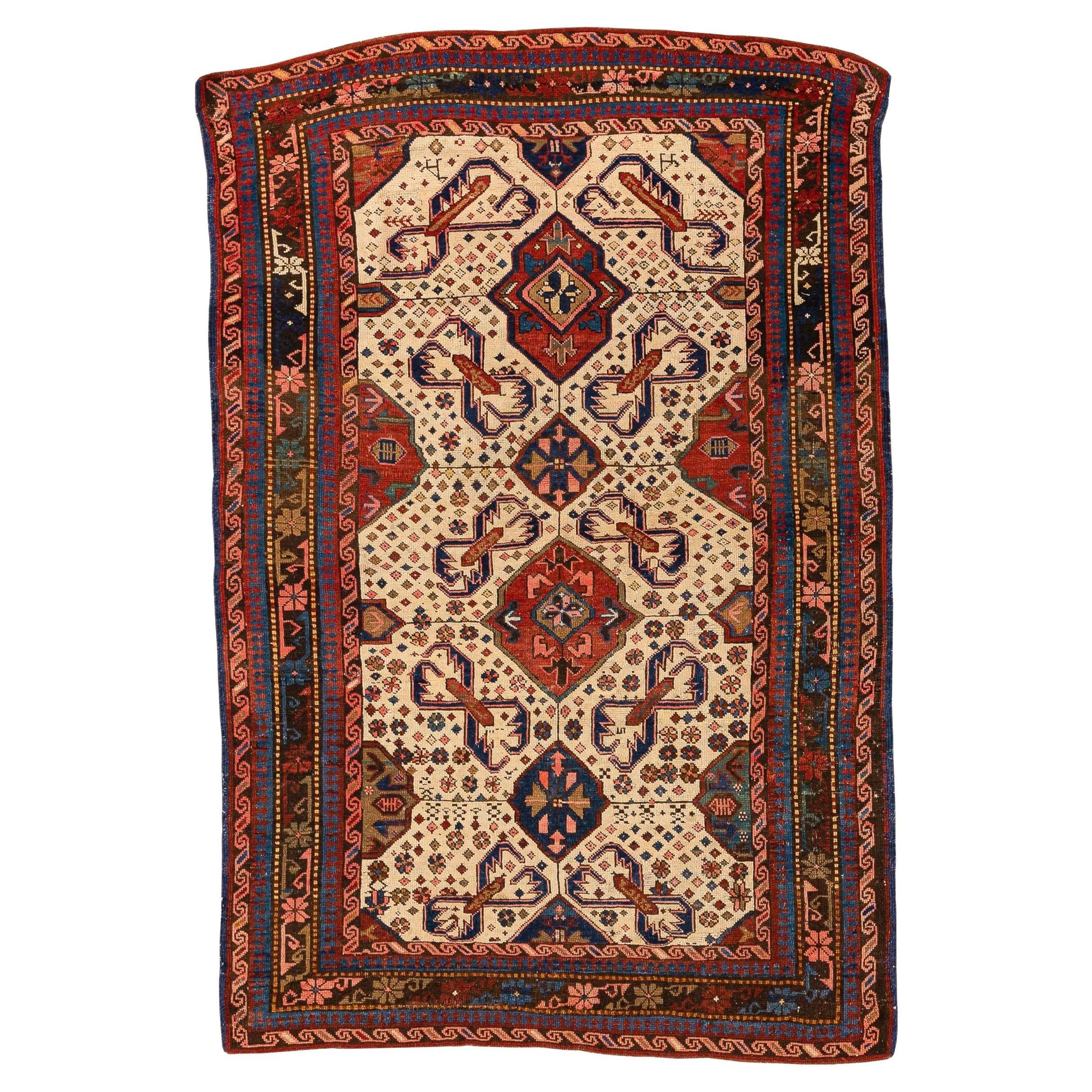 Seychour – Kuba, Northeast Caucasus

This elegant and distinct Seychour rug with an Alpan Crab design features an ivory field filled with geometric figures, including diamonds, flowers, and colourful animals arranged randomly and spontaneously. In