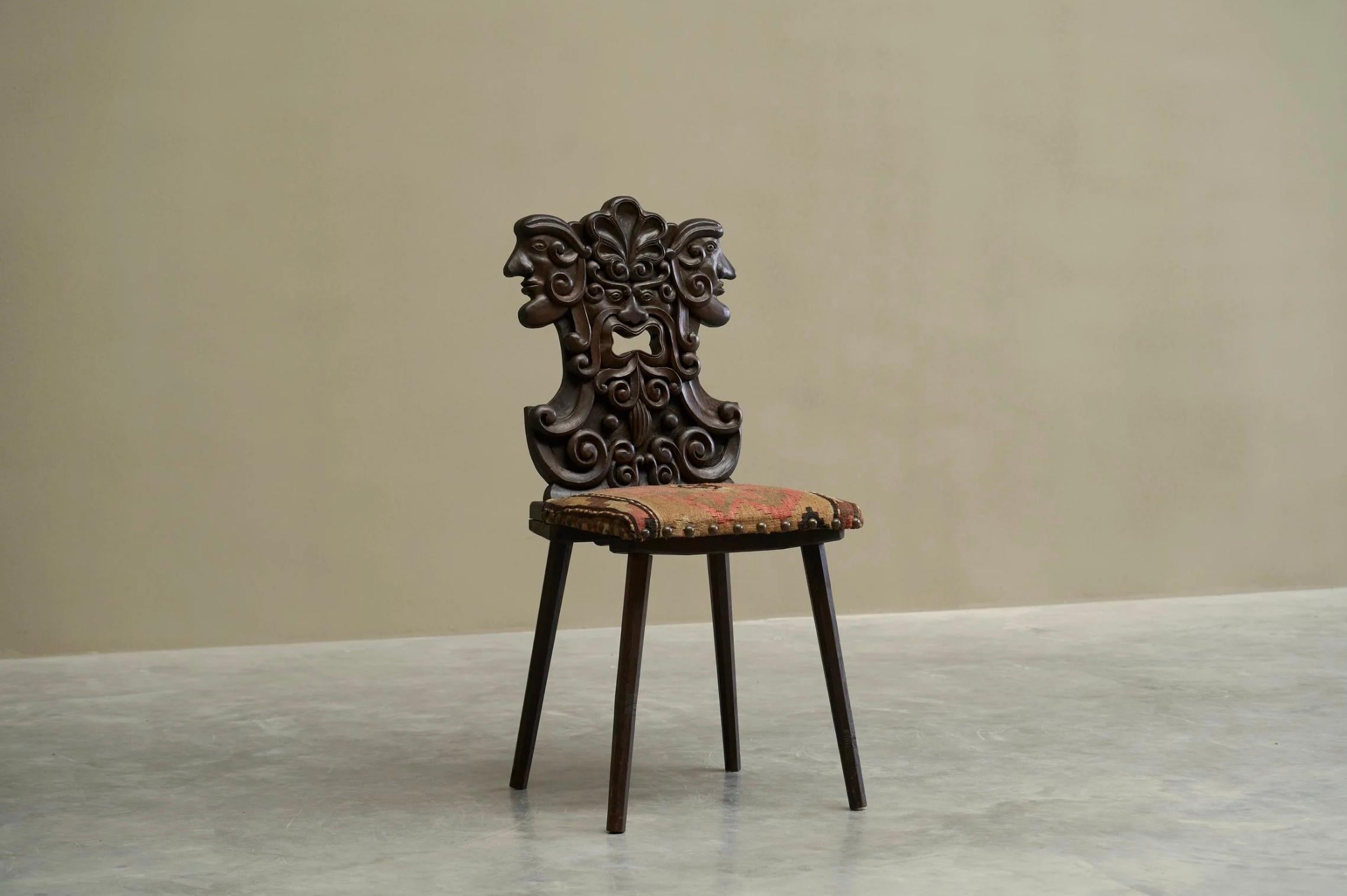Antique Sgabello Style Chair in Carved Wood and Kelim Upholstery. Europe.

A stunning late 19th century / early 20th century Sgabello type folk art chair in hand carved wood with wonderful kelim upholstered seat. Probably Alpine of