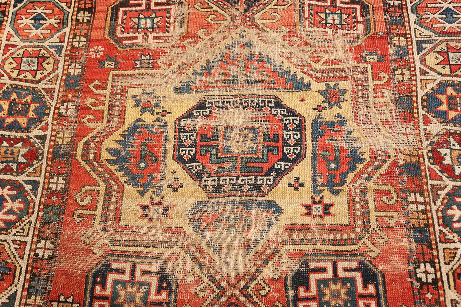 A Beautifully Tribal Antique Worn and Distressed Shabby Chic Caucasian Kazak Rug, Country Of Origin: Caucasus, Circa Date: 1880. Size: 4 ft 10 in x 9 ft 6 in (1.47 m x 2.9 m)

This charming, tribal antique Caucasian Kazak rug was created in the