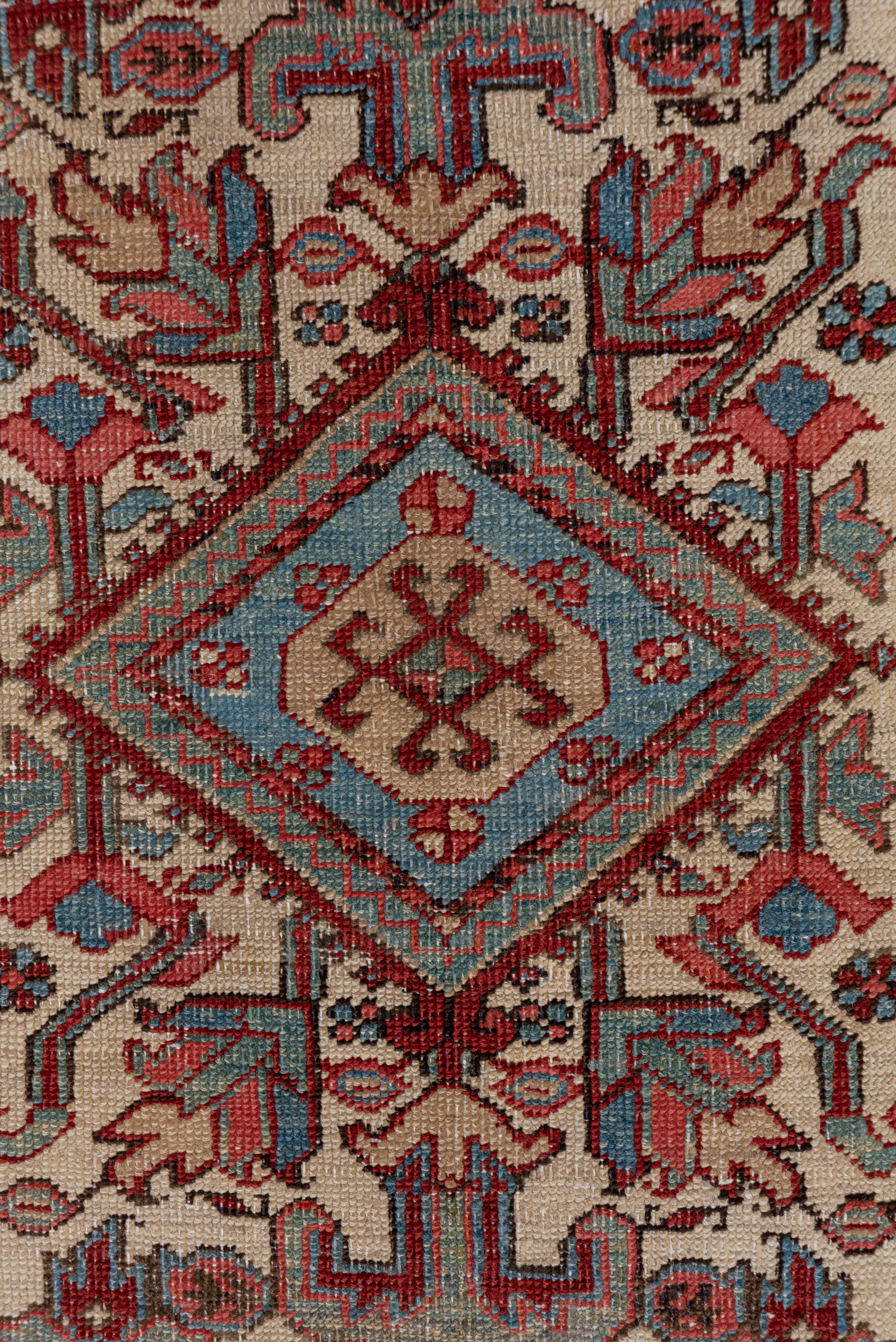 This NW Persian village runner still possesses real character in the three lozenge pole medallion on an ivory field with a fine natural dye palette including rose, light blue, green and red. The light blue border displays a star and slanted bar