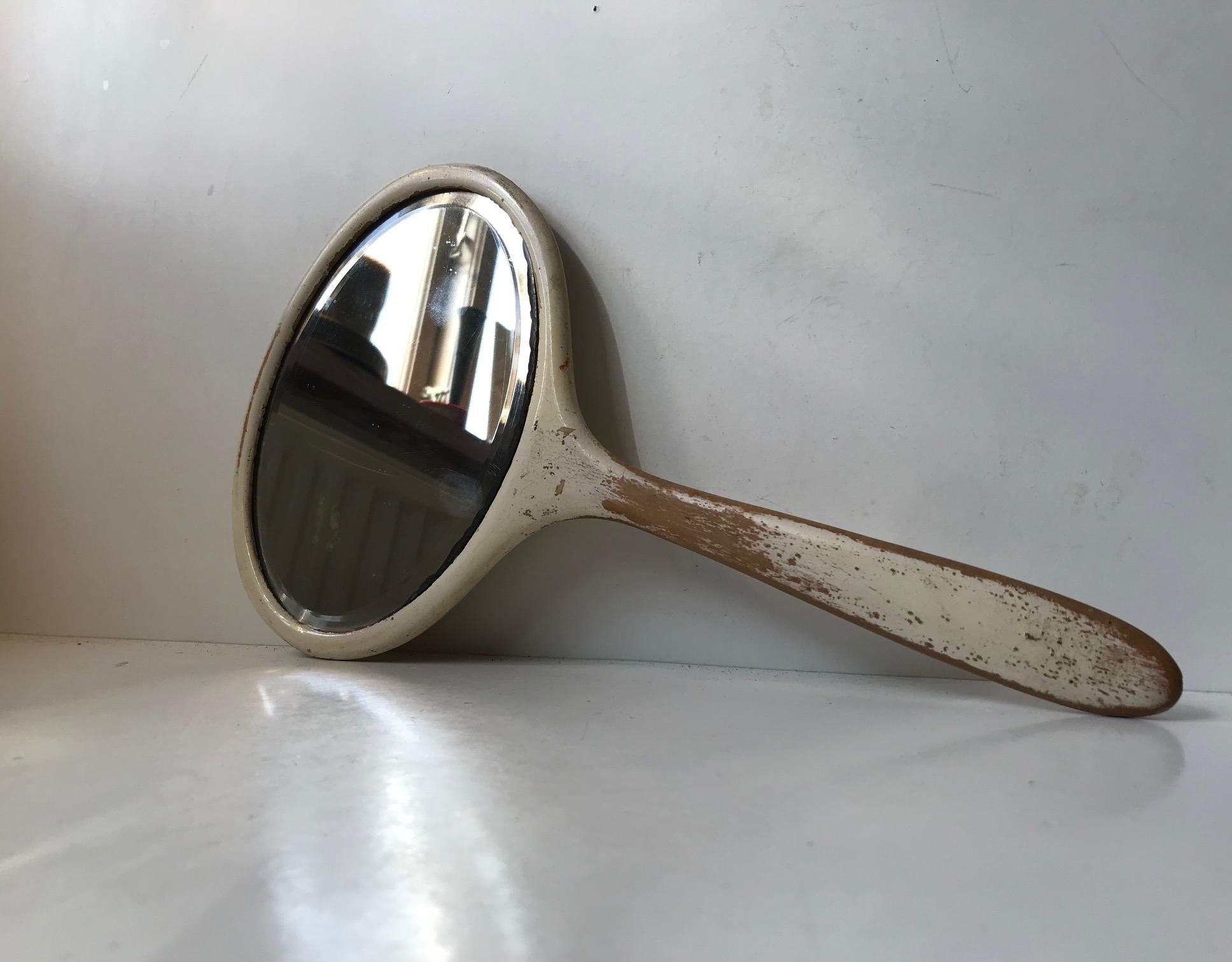 Antique European hand held vanity mirror in lacquered cherrywood and with faceted original mirror glass. Authentic patina and ware suitable for any shabby chic interior.