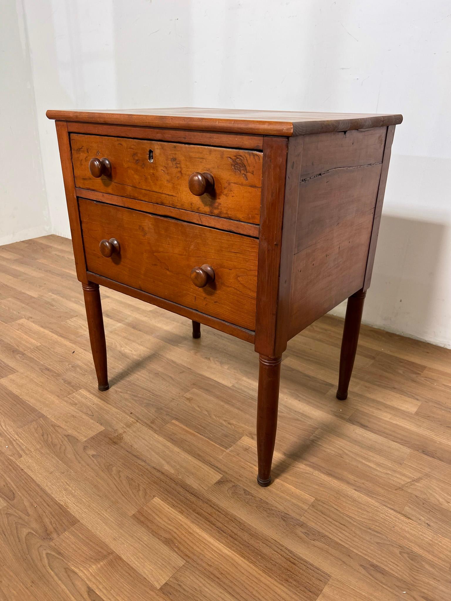 Authentic Shaker two drawer work stand in maple, circa early to mid-19th Century. This piece was crafted in the 