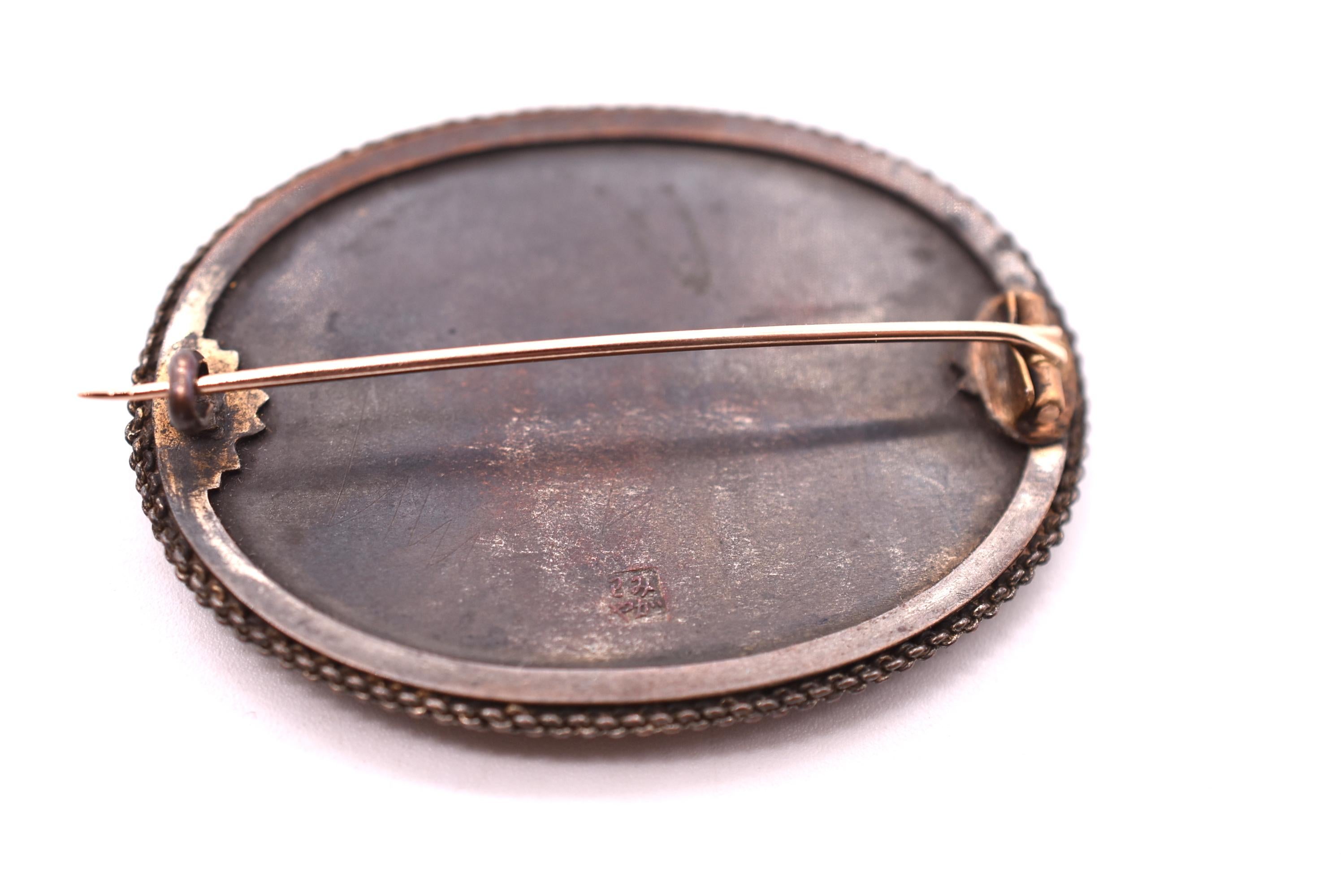 We adore this c 1880 Shakudo brooch featuring a rare image of Mt. Fugi in the background. Shakudo is an ancient Japanese art form which developed from the Samurai tradition of sword making. The metalwork used in the Shakudo technique consists of