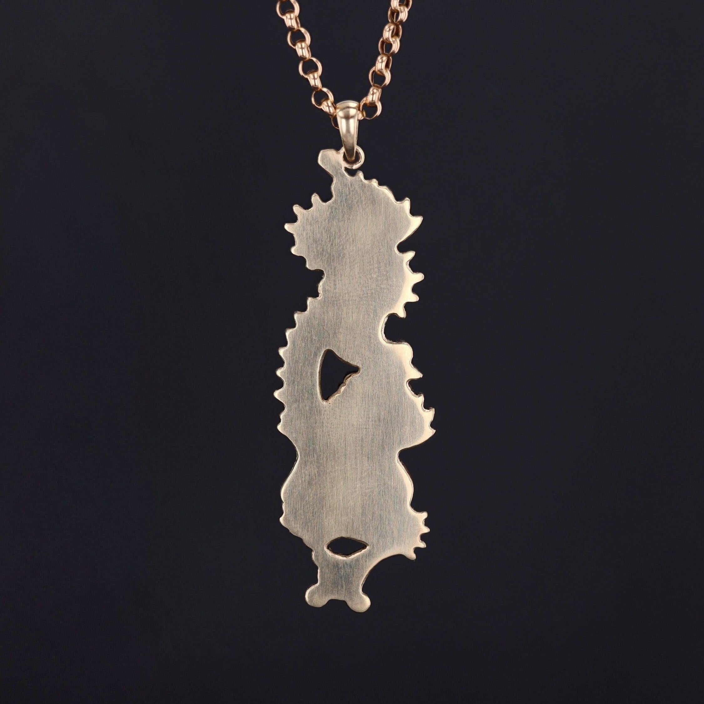 Shakudo is a Japanese mixed metal technique that involved an alloy of copper and gold that was treated to give it a dark black patina.

This mixed metal Shakudo dragon pendant was originally an antique sword ornament that our jeweler transformed by