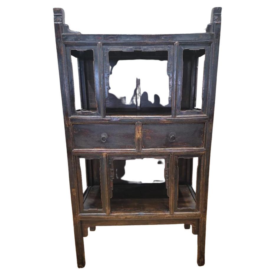 Antique Shanxi province brown black lacquered elmwood bookcase.

This bookcase has 2 shelves and 2 two drawers. This elm and patina piece can also double as a bar.

Circa: 1900s

Dimensions:

W: 42