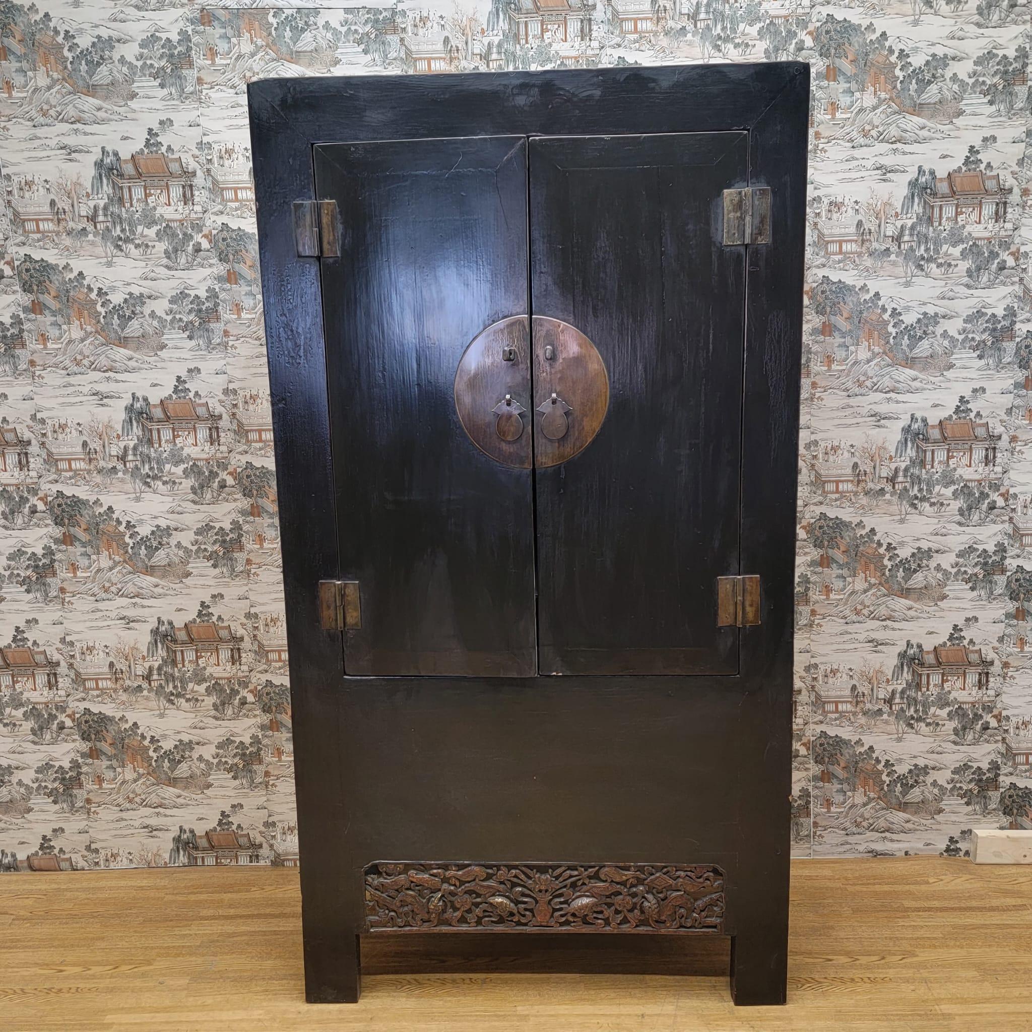 Antique Shanxi province elm cabinet with hand carved arpon.

This Elmwood cabinet with original color and patina and hardware is from the Shanxi Province of China. It has carving details at the bottom with original lacquer. The cabinet suitable to