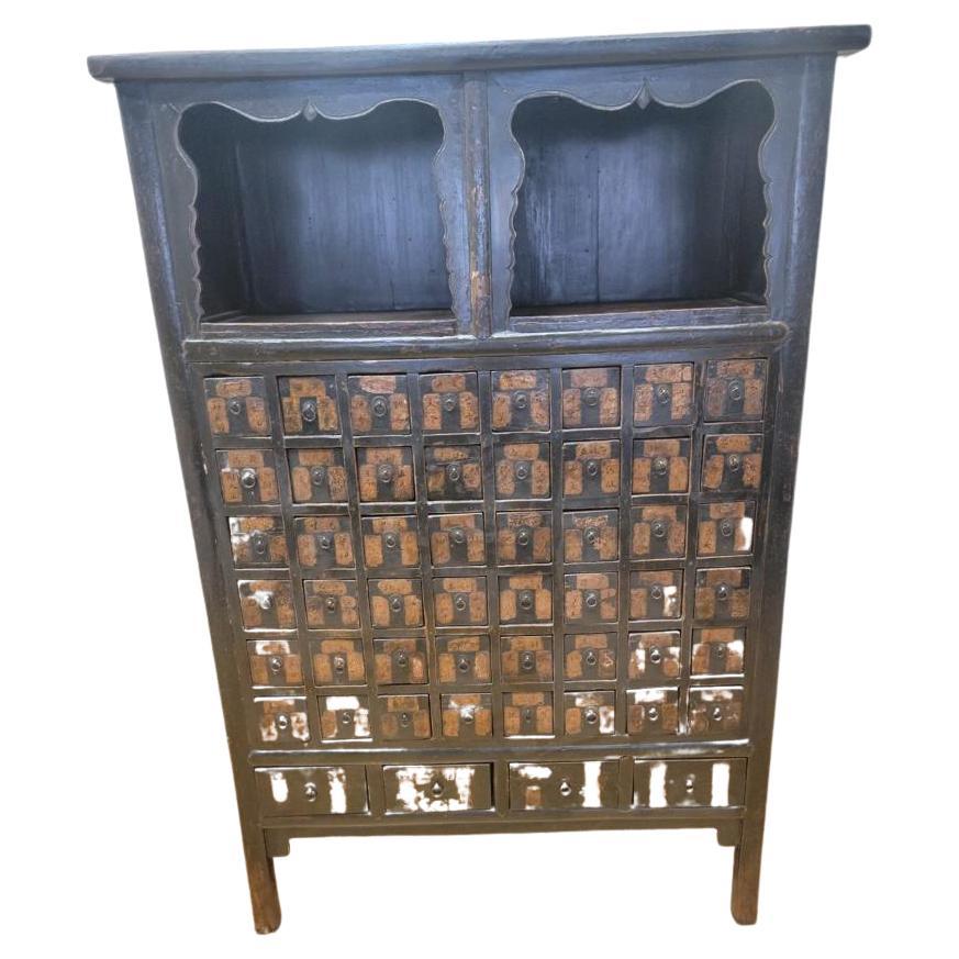 Antique Shanxi Province Hand Painted Black Lacquer Tall Apothecary / Medicine Cabinet 

This apothecary has 48 square drawer and 4 rectangle drawers at the bottom (52 total drawers). The apothecary also has 2 shelves.

This stunning antique