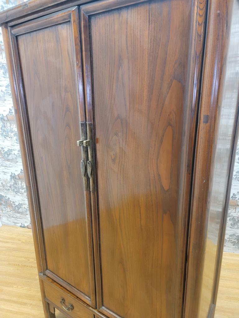 Antique Shanxi Province tall 2 drawer Elmwood cabinet 

This tall cabinet has 2 drawers located at the bottom apron and 2 shelves. The cabinet also has a removable hanging bar. This cabinet has clear lacquer and original patina.

Circa: