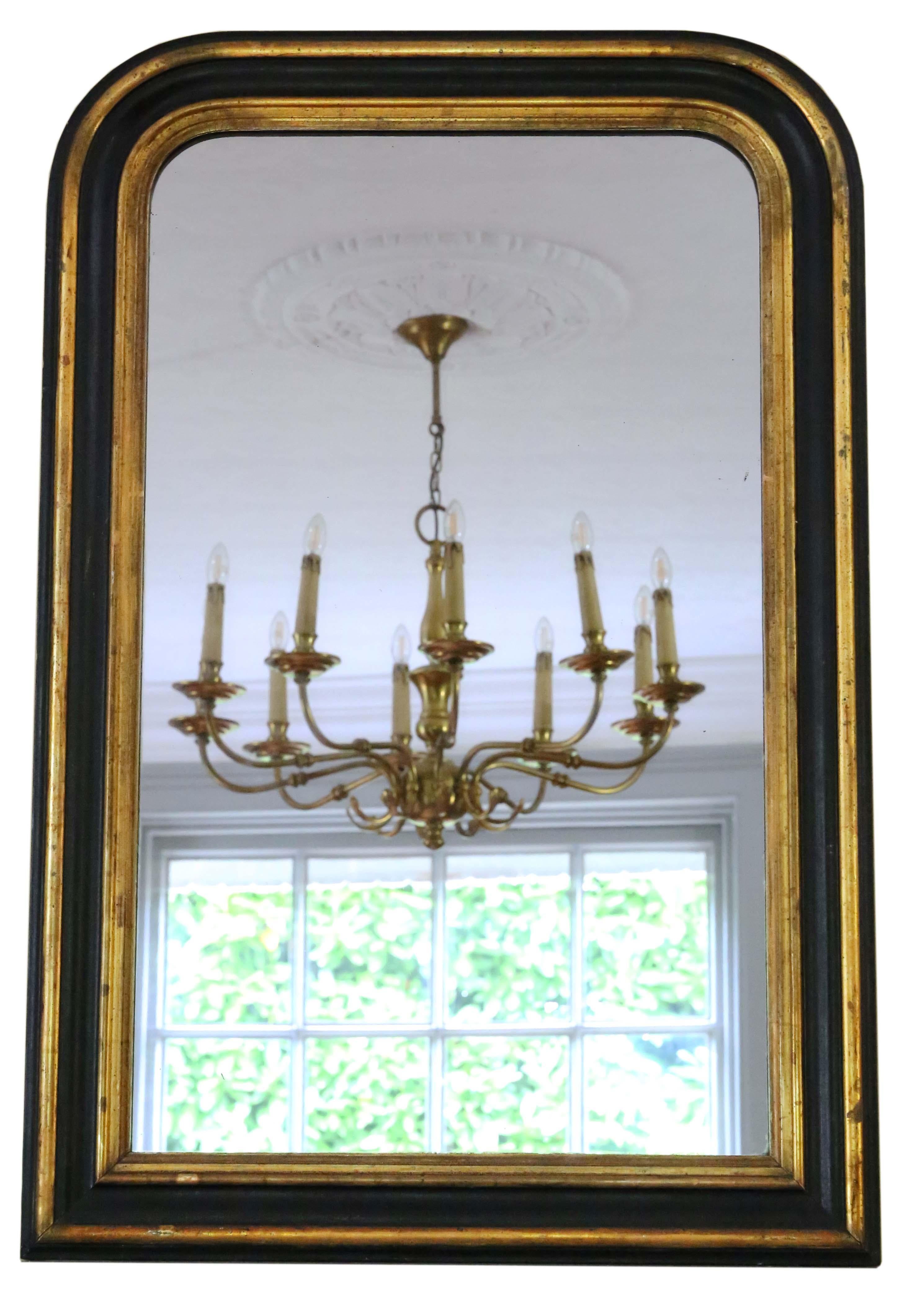 Antique shaped 19th Century large quality black ebonised and gilt overmantle or wall mirror. Lovely charm and elegance. Original finish with minor losses, refinishing and touching up.

This is a lovely, rare mirror. A bit different and quite
