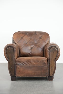 Antique sheepskin armchair with a luxurious look and finished with wood