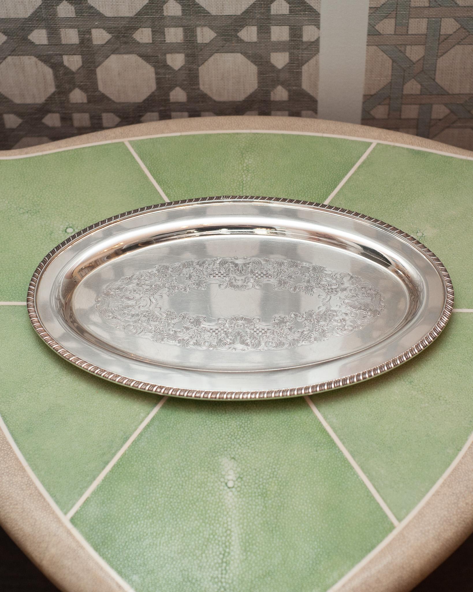 An antique Sheffield Reproduction silver plate oval serving tray with engraved interior. Silver plated copper.