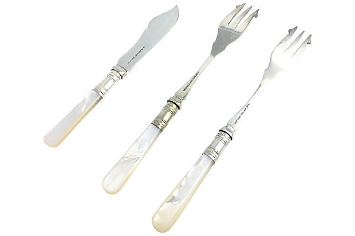 Antique Sheffield silver plate and mother of pearl three-piece fish set with one fish knife and pair of matching seafood forks. Mother of pearl handles. A silver plate band and engraved design borders the edge of the knife. The pair of matching