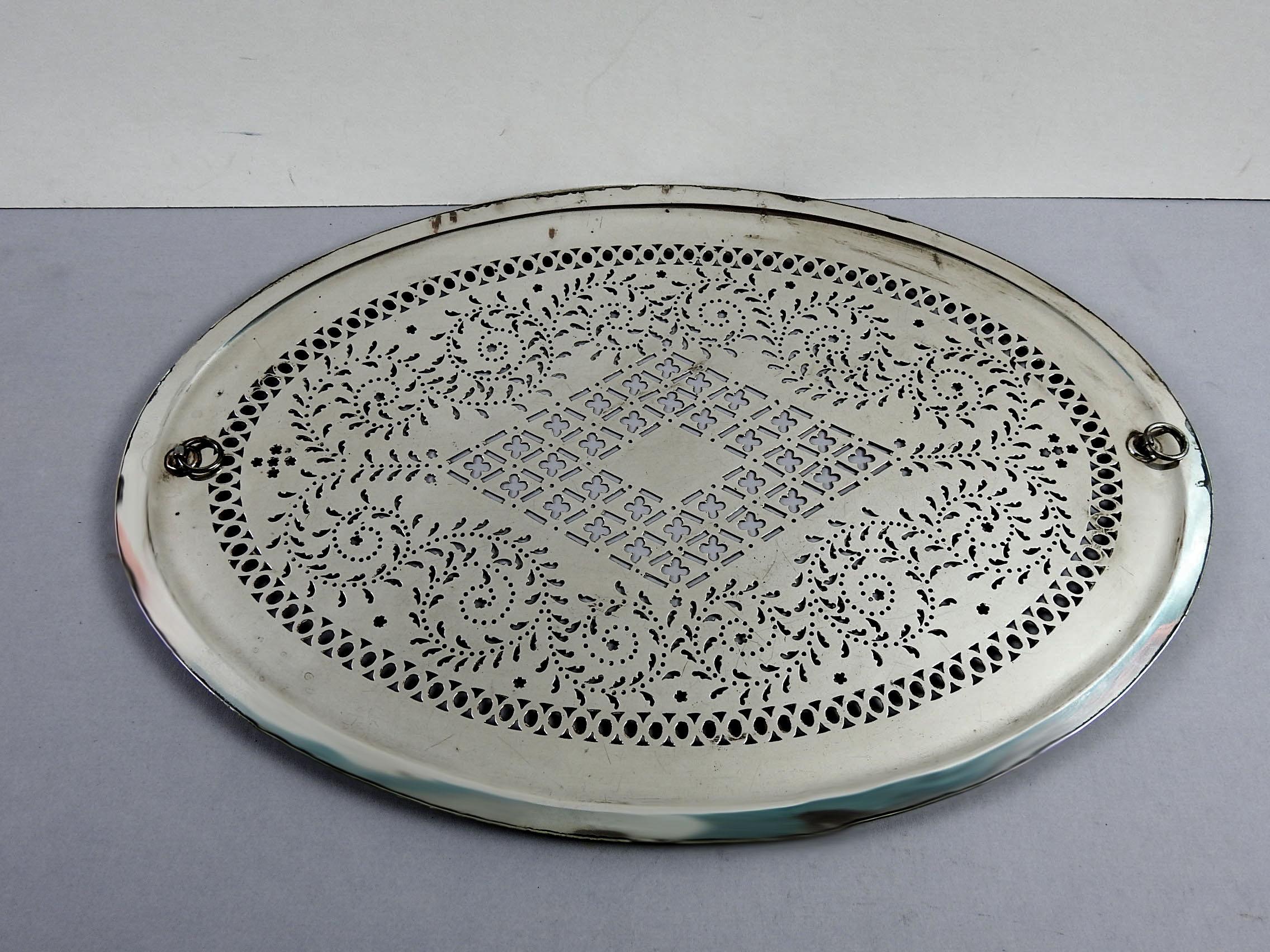 Circa 1815 Sheffield silverplate over copper and hand pierced mazarine tray (strainer). No markings, attached rings for lifting. Overall patina, minor plate loss.
