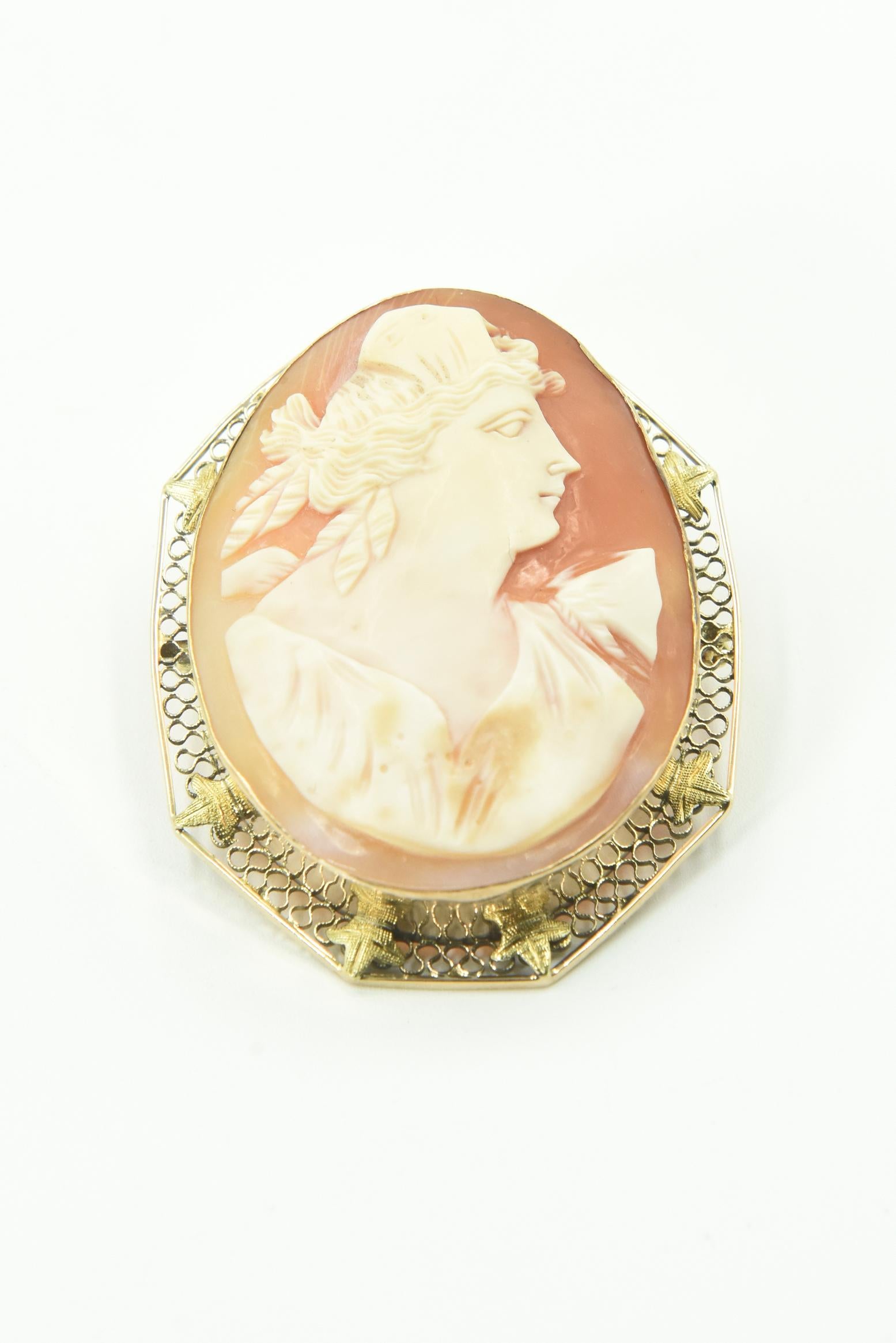 Victorian shell cameo Roman woman portrait hand carved & mounted into a 14k gold brooch pendant.  The frame work is traditional filigree, with lovely, detailed leaves surrounding the solid bezel frame. The cameo itself is perfectly carved, a lady in