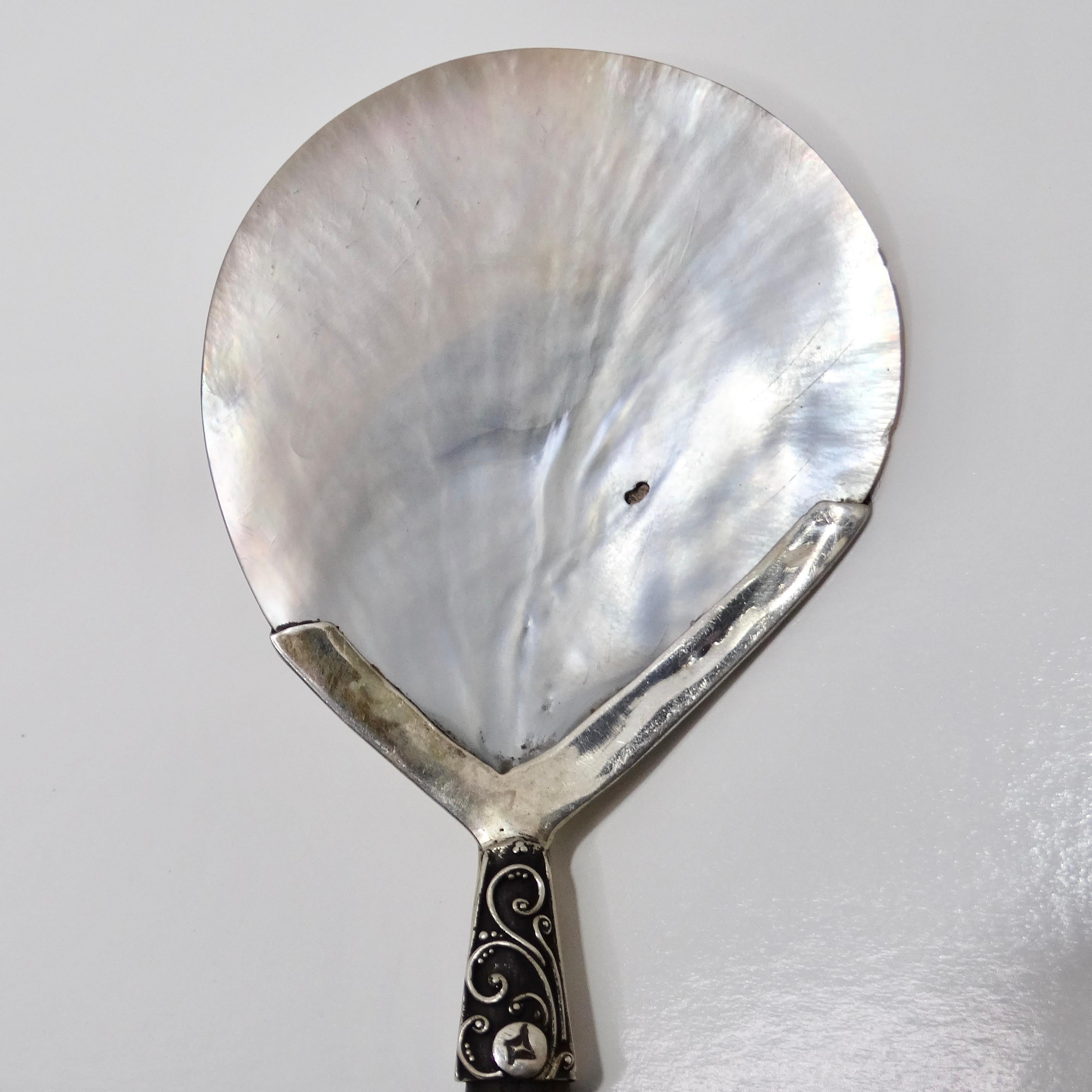 Introducing the Antique Shell Motif Pure Silver Spoon, a truly exceptional piece from the early 1900s that captures the essence of timeless luxury and sophistication.

Crafted with meticulous attention to detail, this exquisite spoon features a