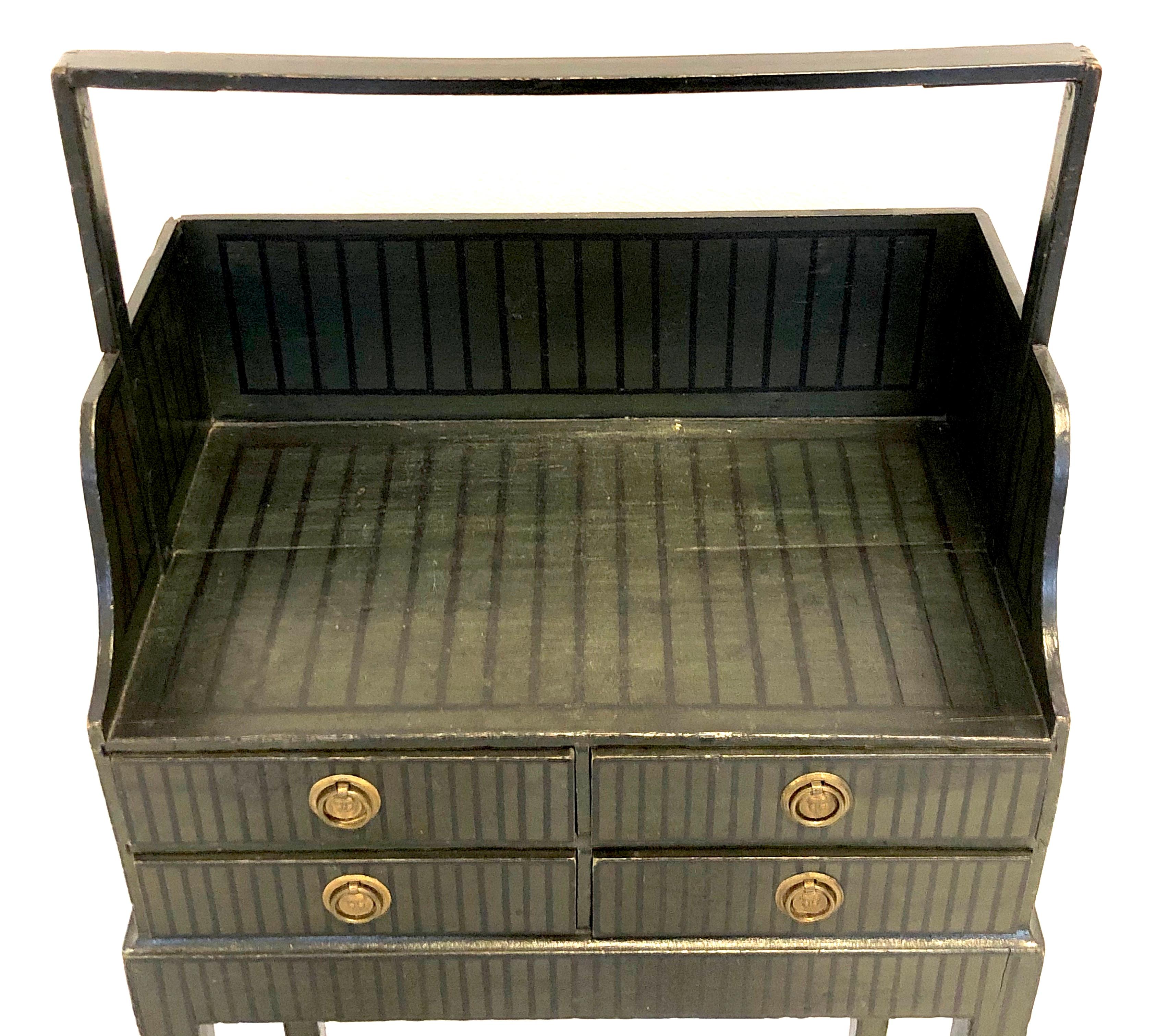 This extremely rare, one of a kind, so called 'Cheveret', is made in England in the Sheraton period, circa 1790, out of beechwood. It still has it's original dark green paint with black stripes. The four small drawers have their original round brass