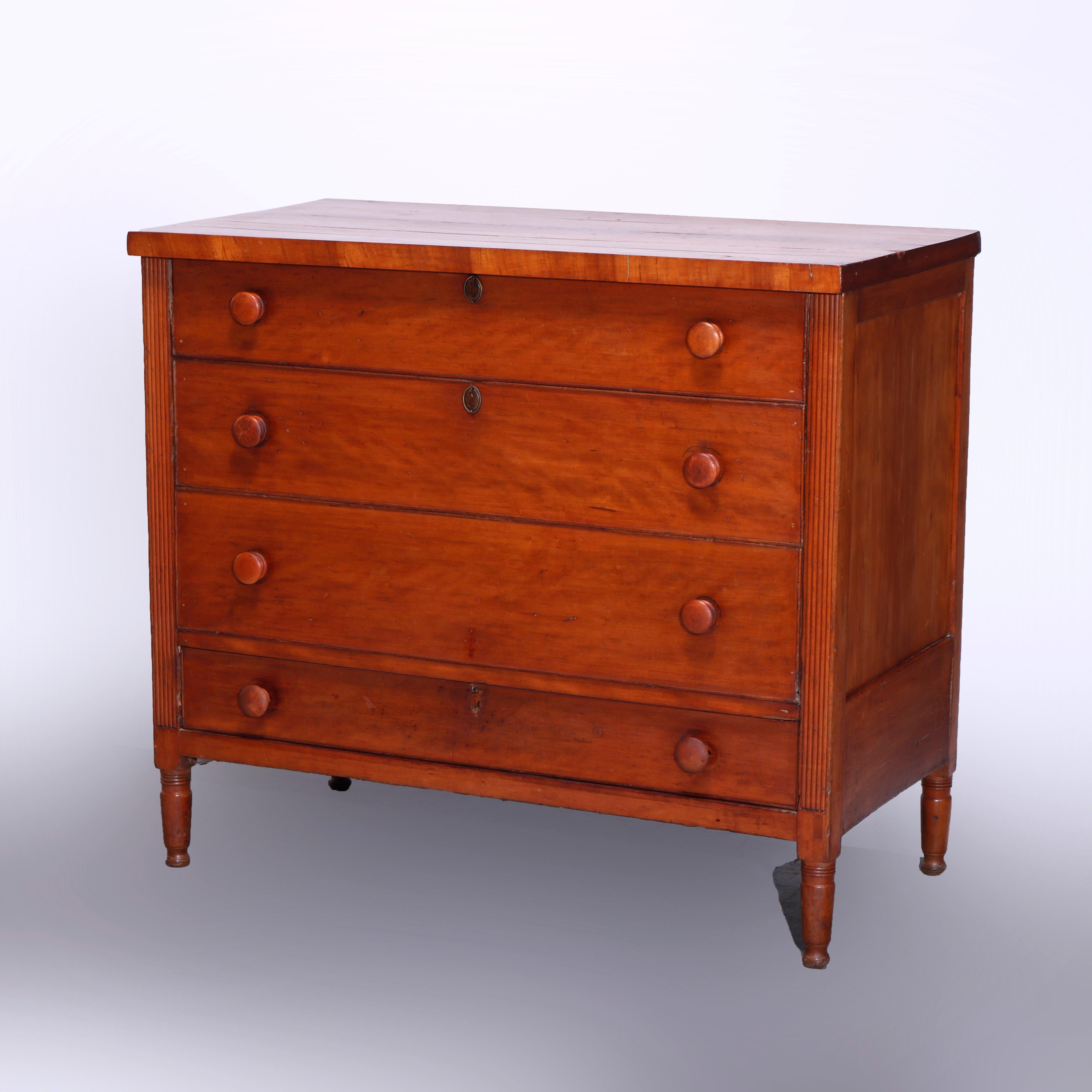 An antique Sheraton blanket chest offers cherry construction with top opening to painted interior and having three faux drawers over single lower drawer, flanked by reeded supports and raised on turned legs, c1830

Measures - 35''H x 40''W x