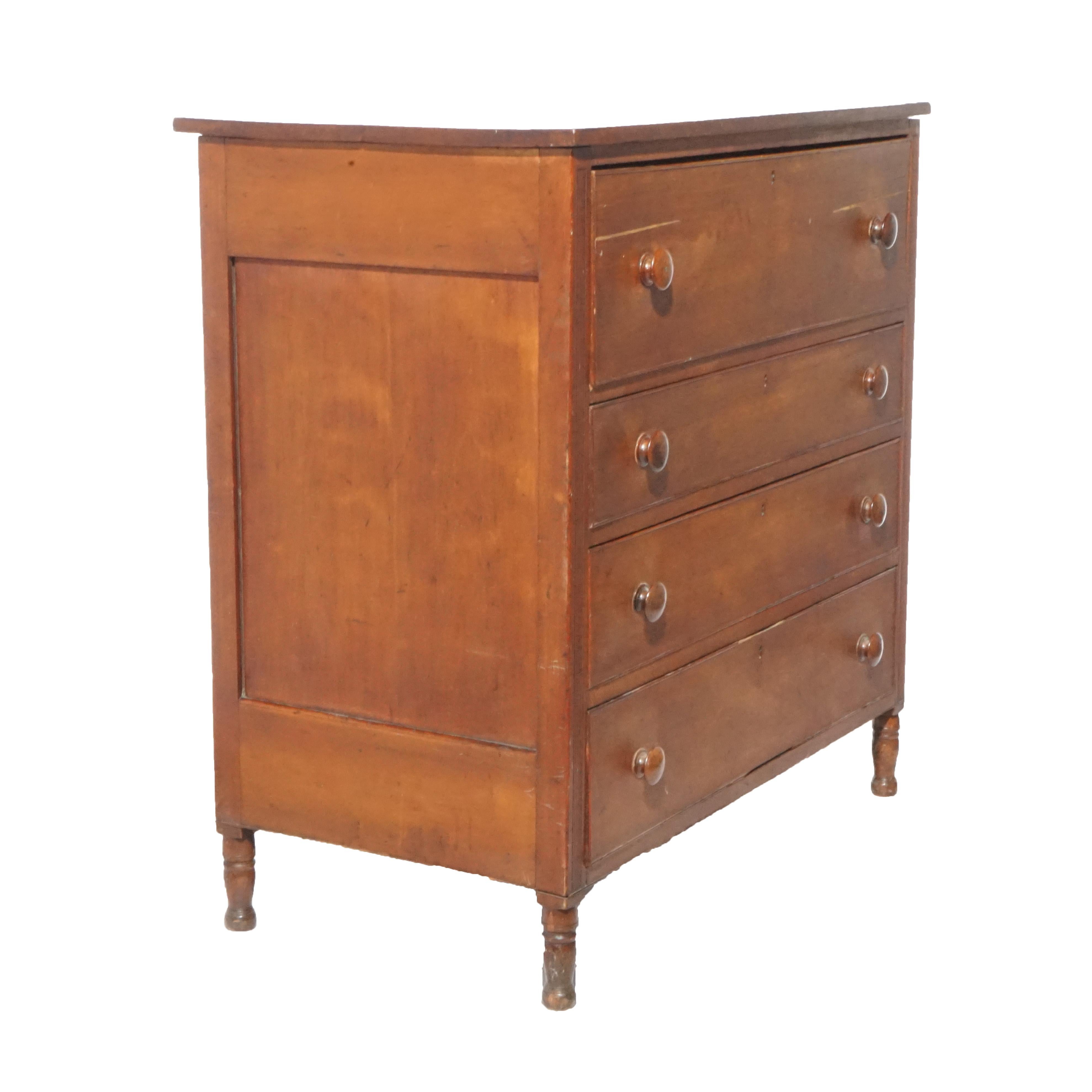 An antique Sheraton Butler's chest offers paneled cherry construction with drop 
front desk opening to interior with pigeon holes and drawers over three long drawers, raised on turned feet, c1830

Measures- 42.75'' H x 41.75'' W x 24.25'' D.

*Ask