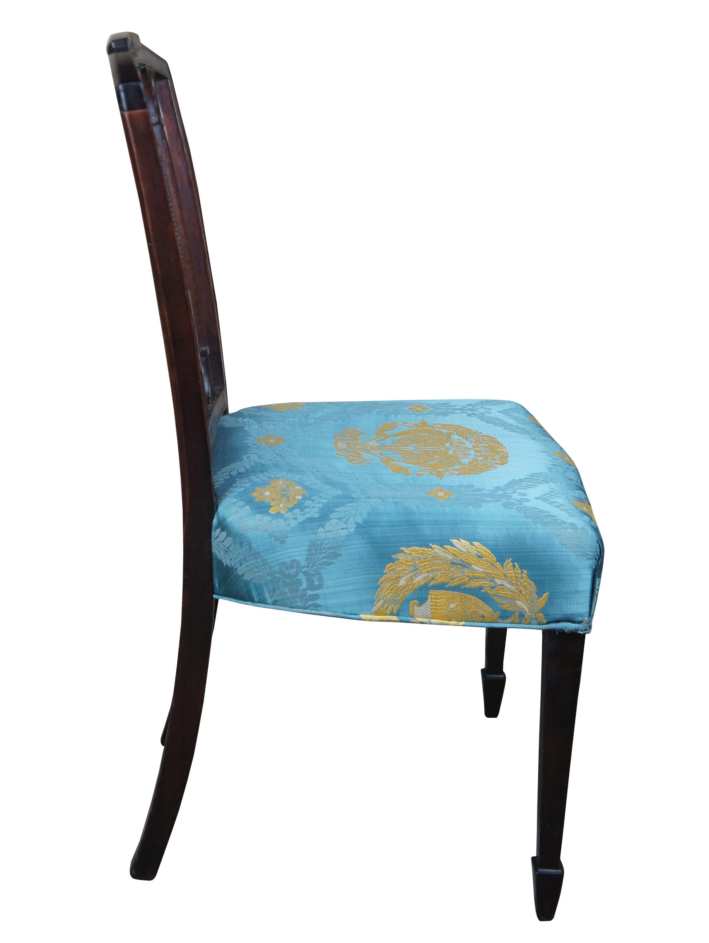Antique Sheraton side chair. Features a carved and split back with neoclassical elements, leading to scalamadre seat with square tapered legs that lead to a spade foot.
  