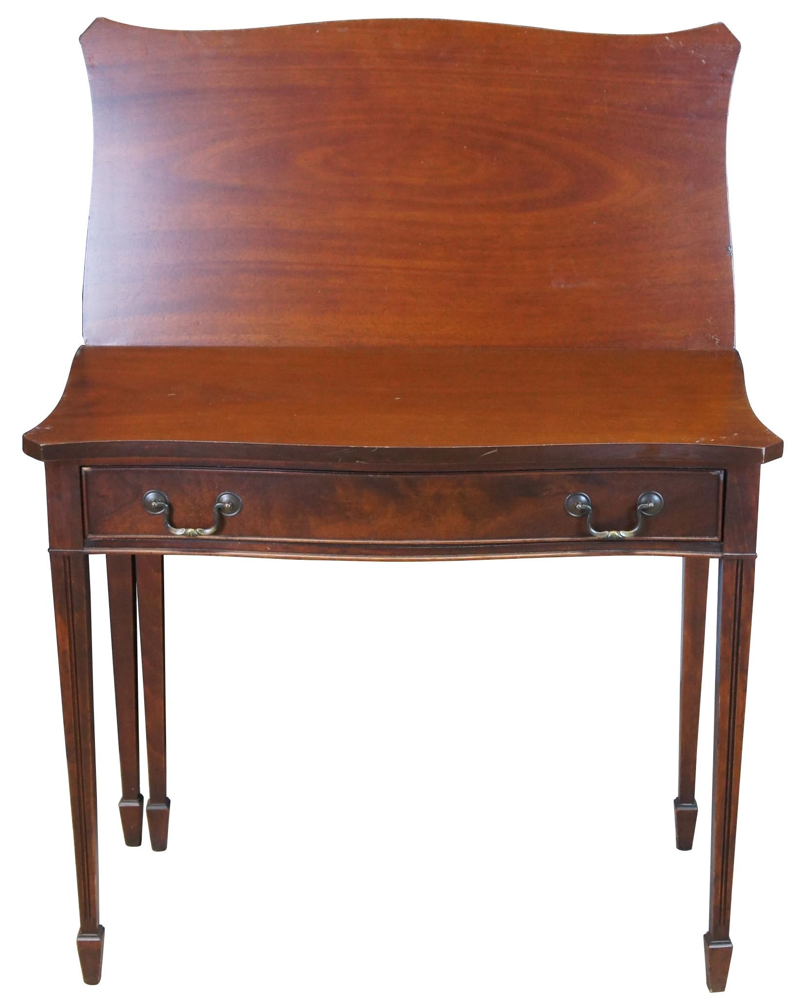 Antique Sheraton style flip top gateleg game table or console. Made of mahogany featuring serpentine form with one drawer and fluted tapered legs. Marked in drawer, Finished with DuPont Duco lacquer.

Flips open to 35.5