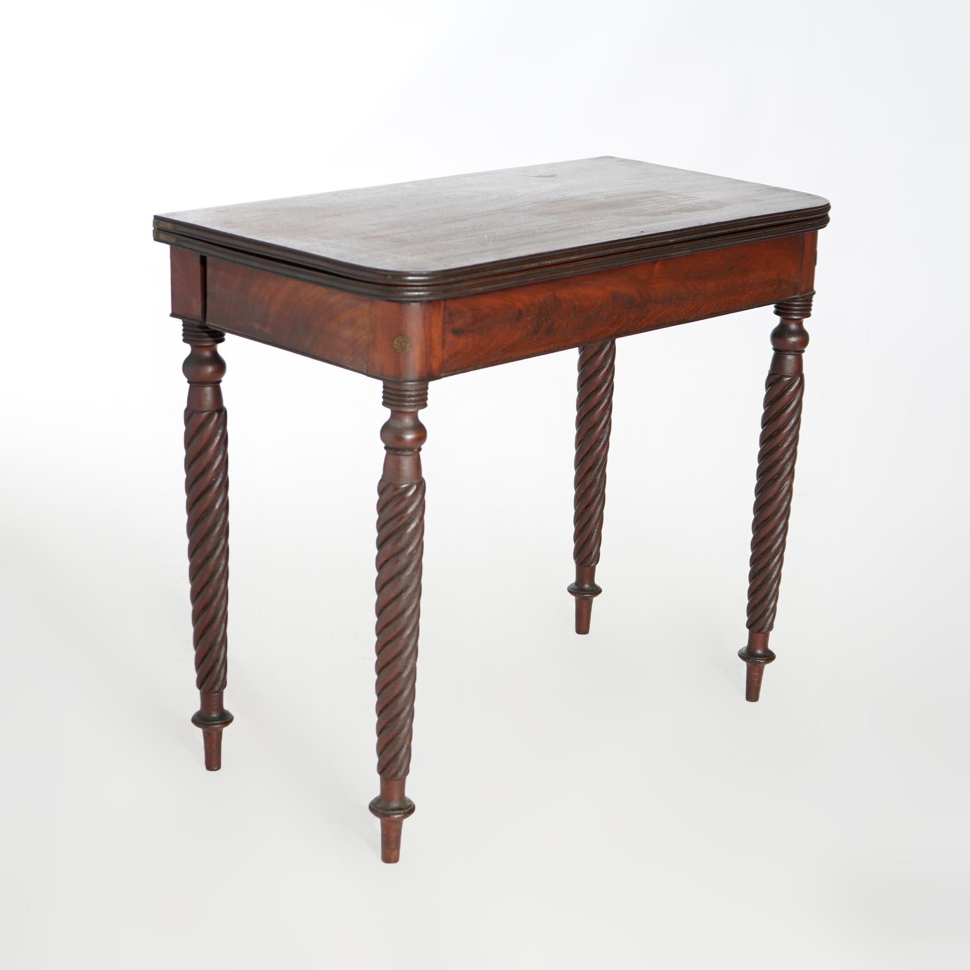 An antique Sheraton game table offers mahogany construction with flip top raised on carved rope twist legs, c1830

Measures- 30.25'' H x 35'' W x 17.75'' D; 35.5'' x 35'' top.