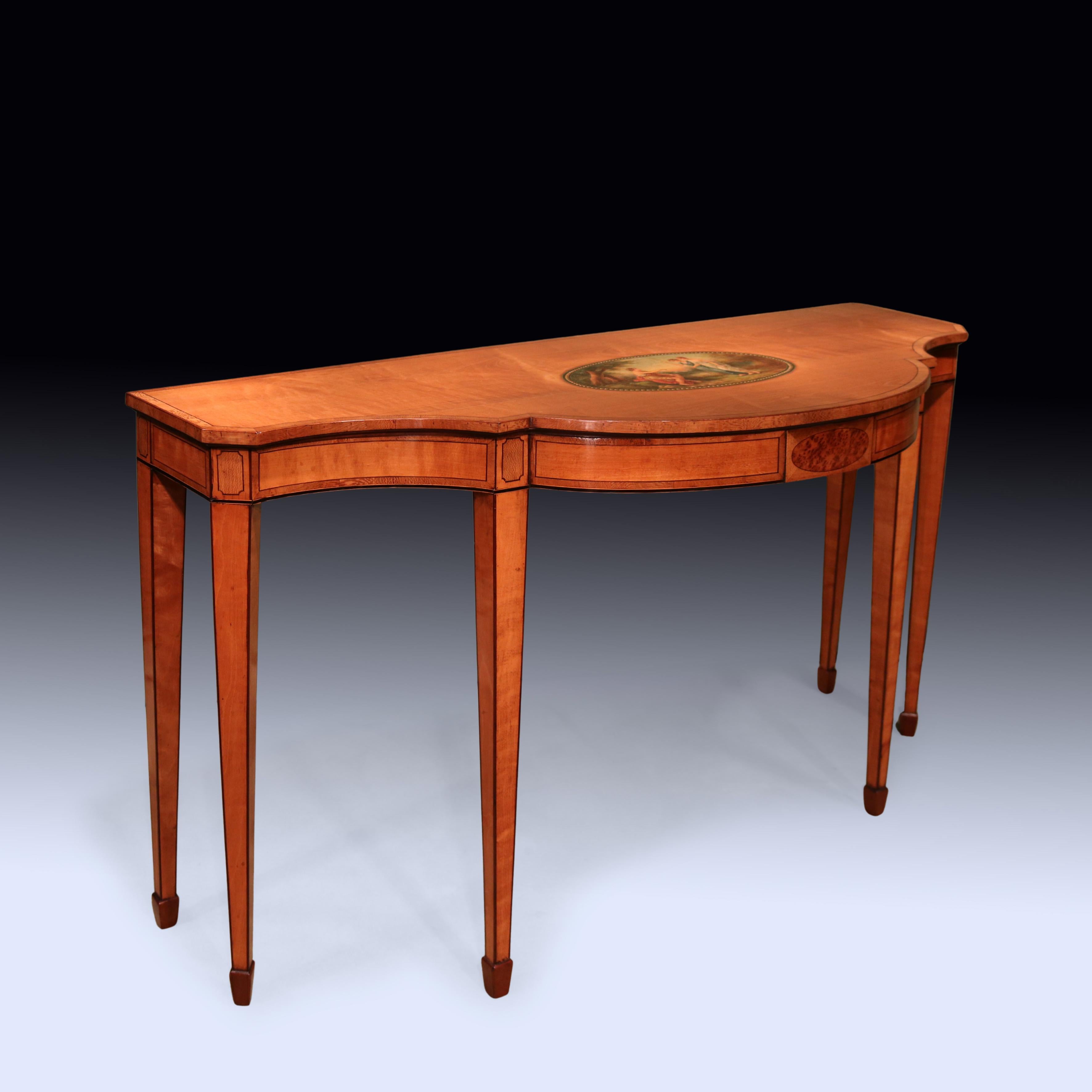 A fine quality late 18th Century Sheraton Period Satinwood Console Table, boxwood and ebony inlaid throughout with unusual Lacewood banding and panelling.  The Table having canted corner concave and bow top centred by oval painted panel after