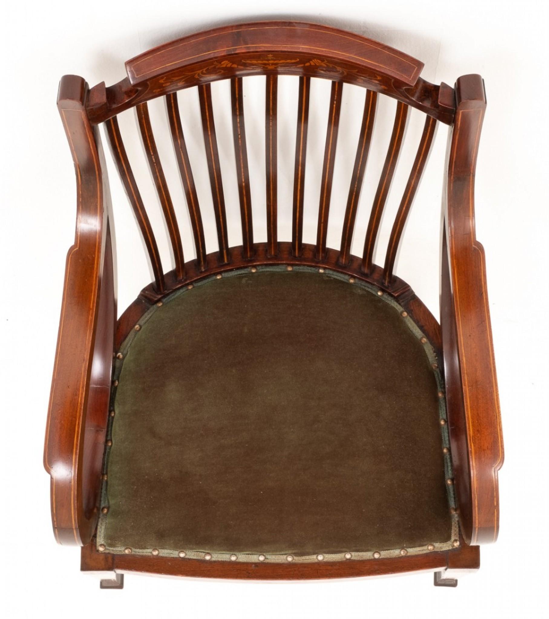 Sheraton Revival Mahogany Inlaid Elbow Chair.
This piece having swept arms and the cresting rail with floral marquetry inlays.
The Tapering legs having a shell patre to the tops and the whole chair having boxwood string inlays.