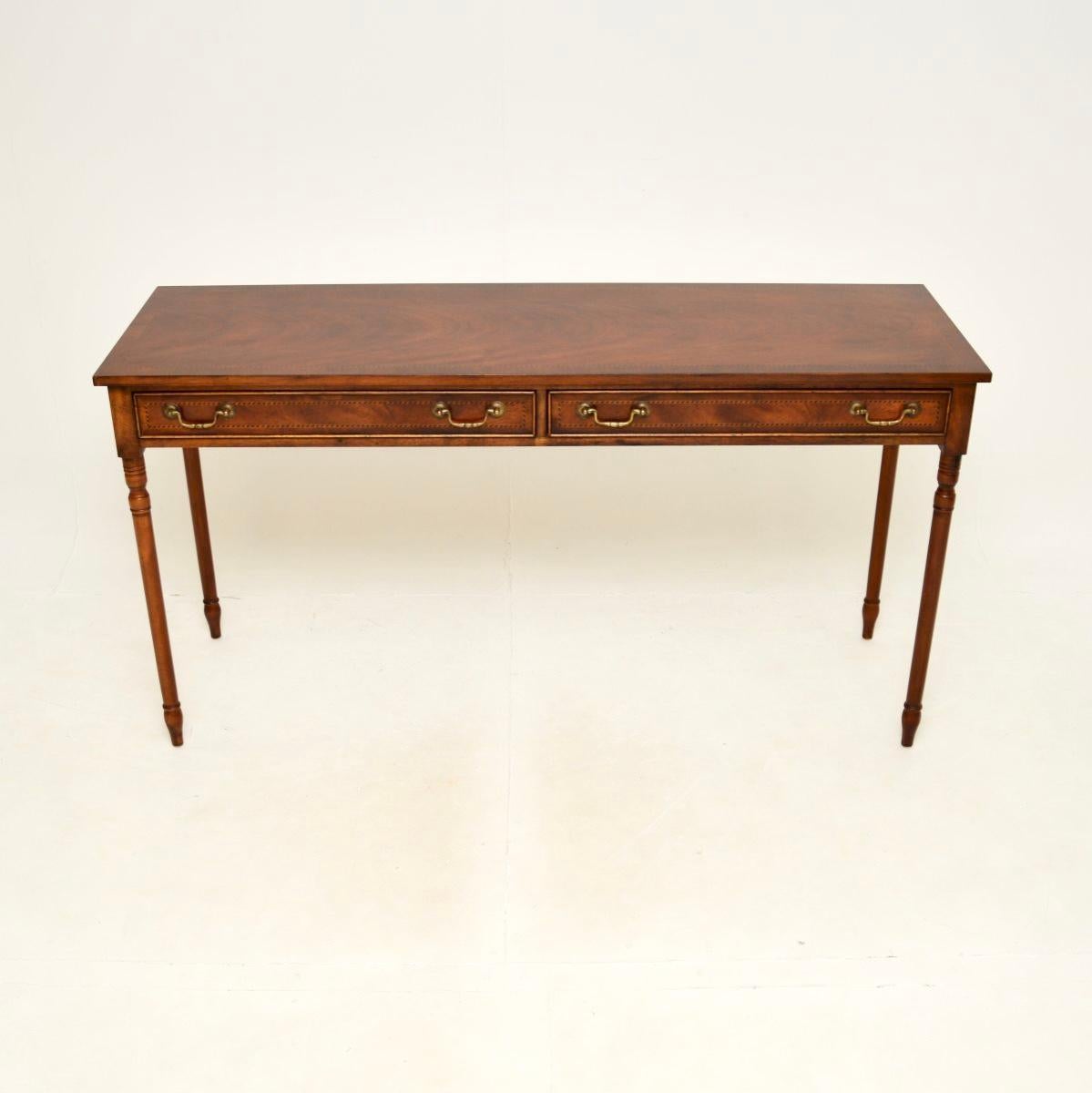 A large and impressive antique console table. This was made in England, it dates from around the 1930’s.

It is of superb quality, it is a very useful size; quite long, elegant and slender. The top and drawer fronts have cross banded edges and