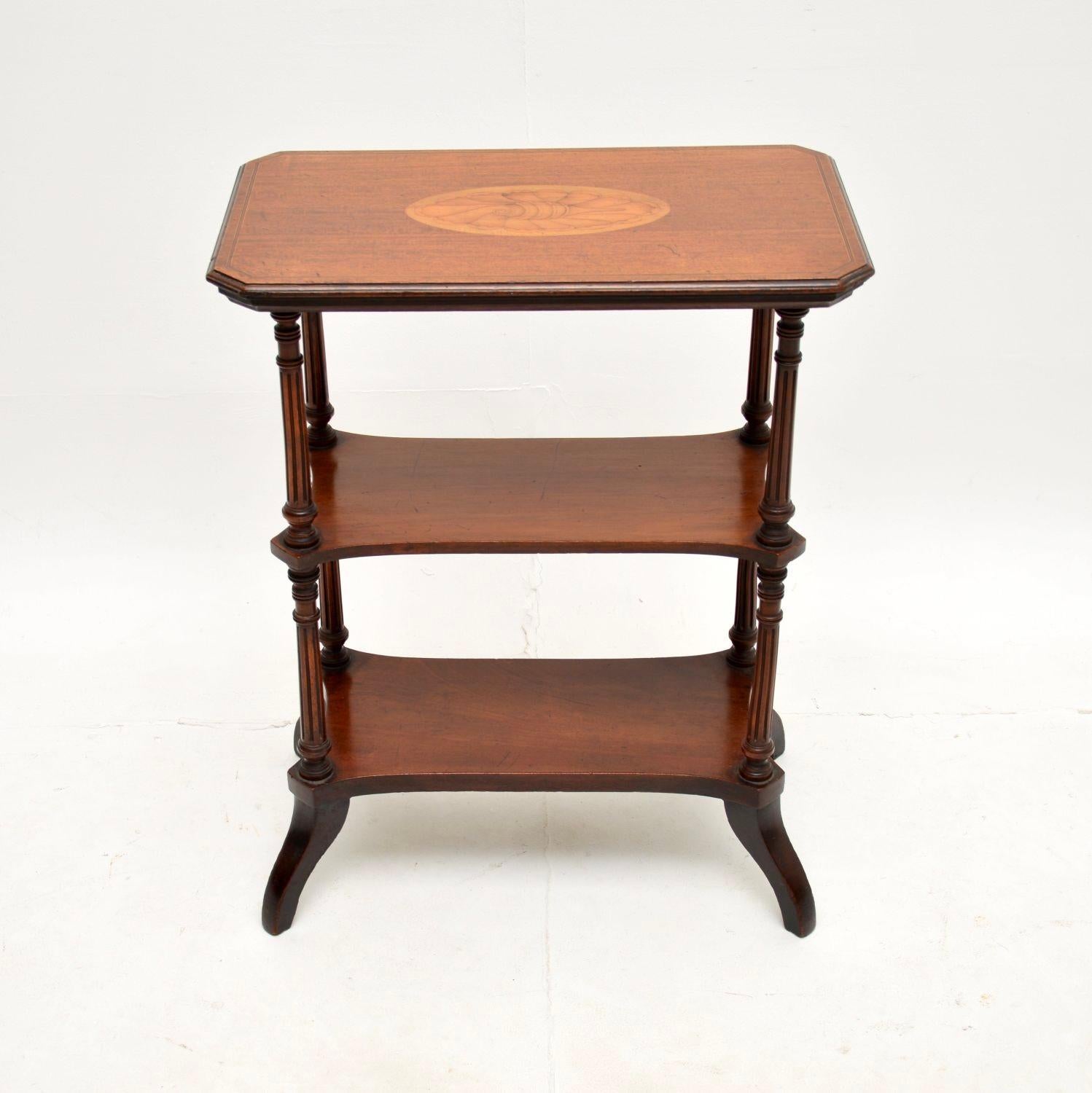 A beautiful antique inlaid three tier side table. This was made in England, it dates from around the 1880-90 period.

It is very well made and is a handy size, with three useful tiers. The top tier is beautifully inlaid with satinwood and a shell