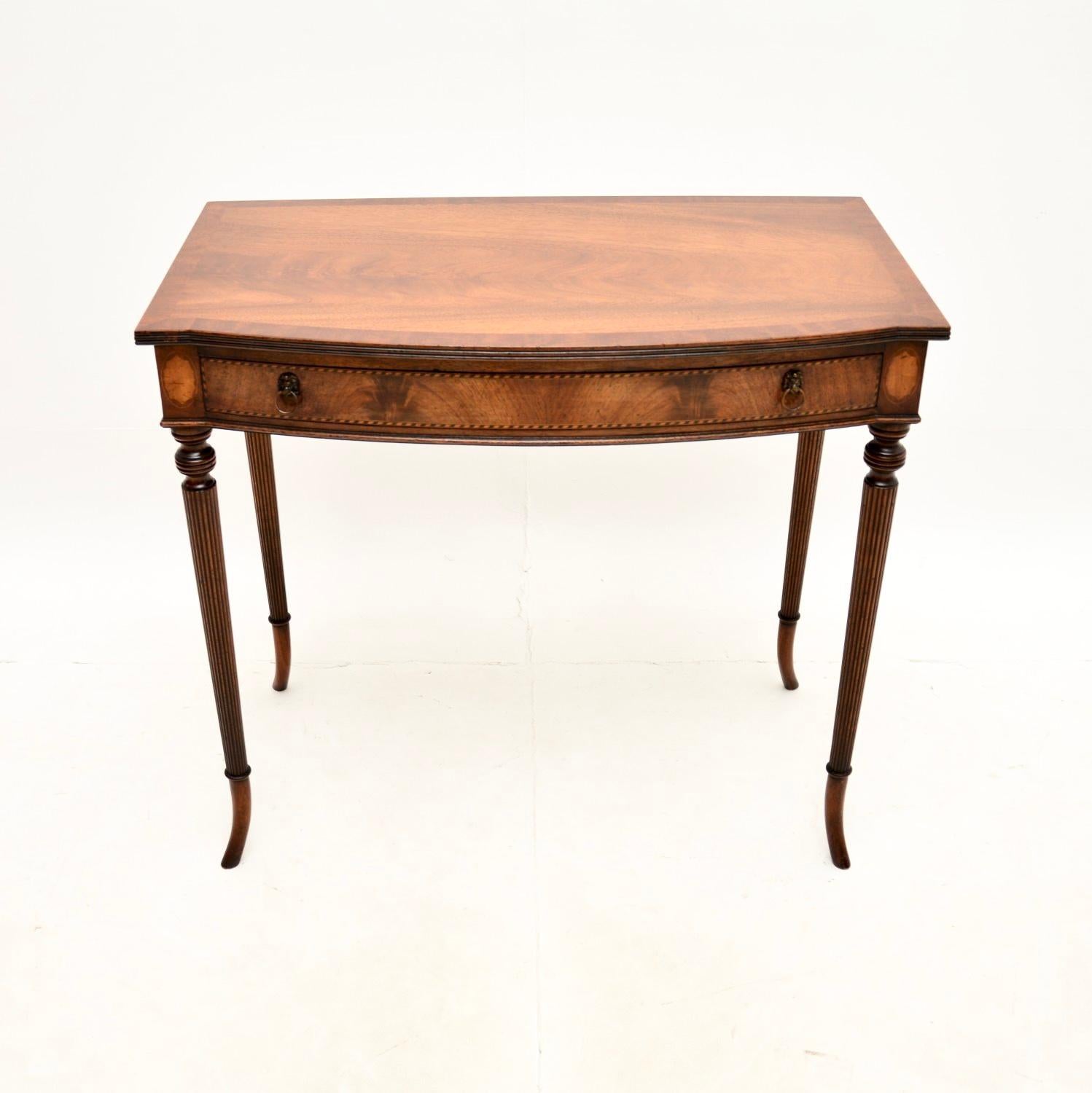A beautiful and elegant antique writing / side table. This was made in England, it dates from around the 1920’s.

It is of extremely fine quality with a gorgeous and useful design. This is a great size to be used as a small desk or as a console side