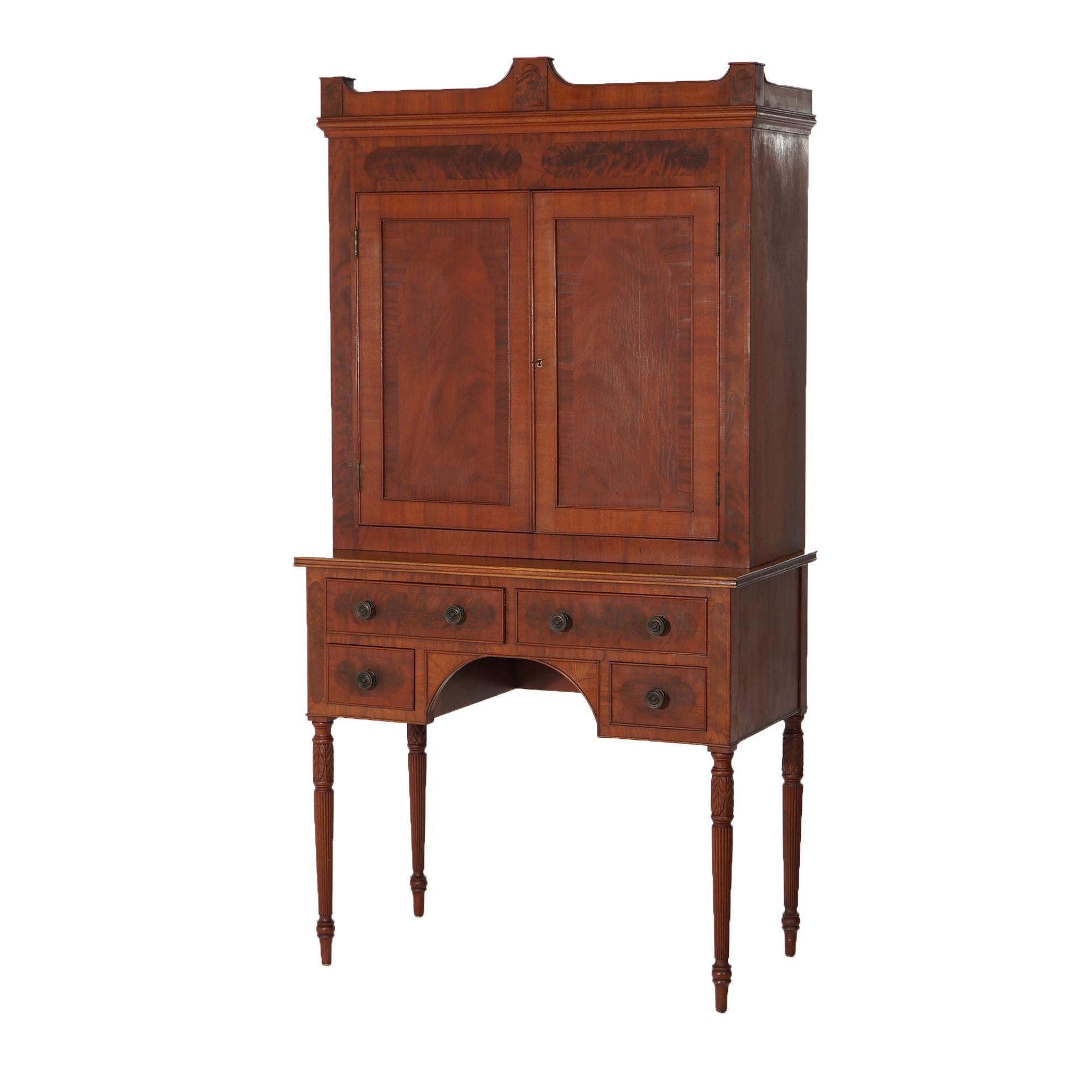 ***Inquire About Lower In-House Shipping Rates - Reliable Service & Fully Insured***
An antique Sheridan secretary offers flame mahogany construction with upper having a shaped crest over case with double doors opening to shelved interior; lower