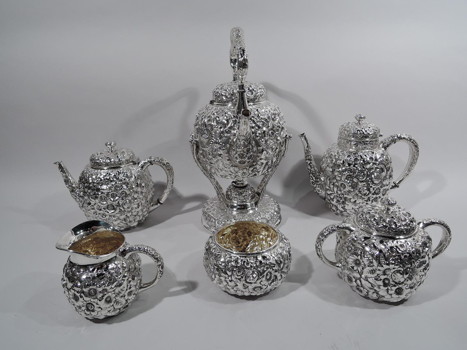 Turn of the century sterling silver tea set. Made by Shiebler in New York. This set comprises 6 pieces: Hot water kettle on stand, coffeepot, teapot, creamer, sugar, and waste bowl.

Globular and oval bodies. Covers domed (kettle and pot covers