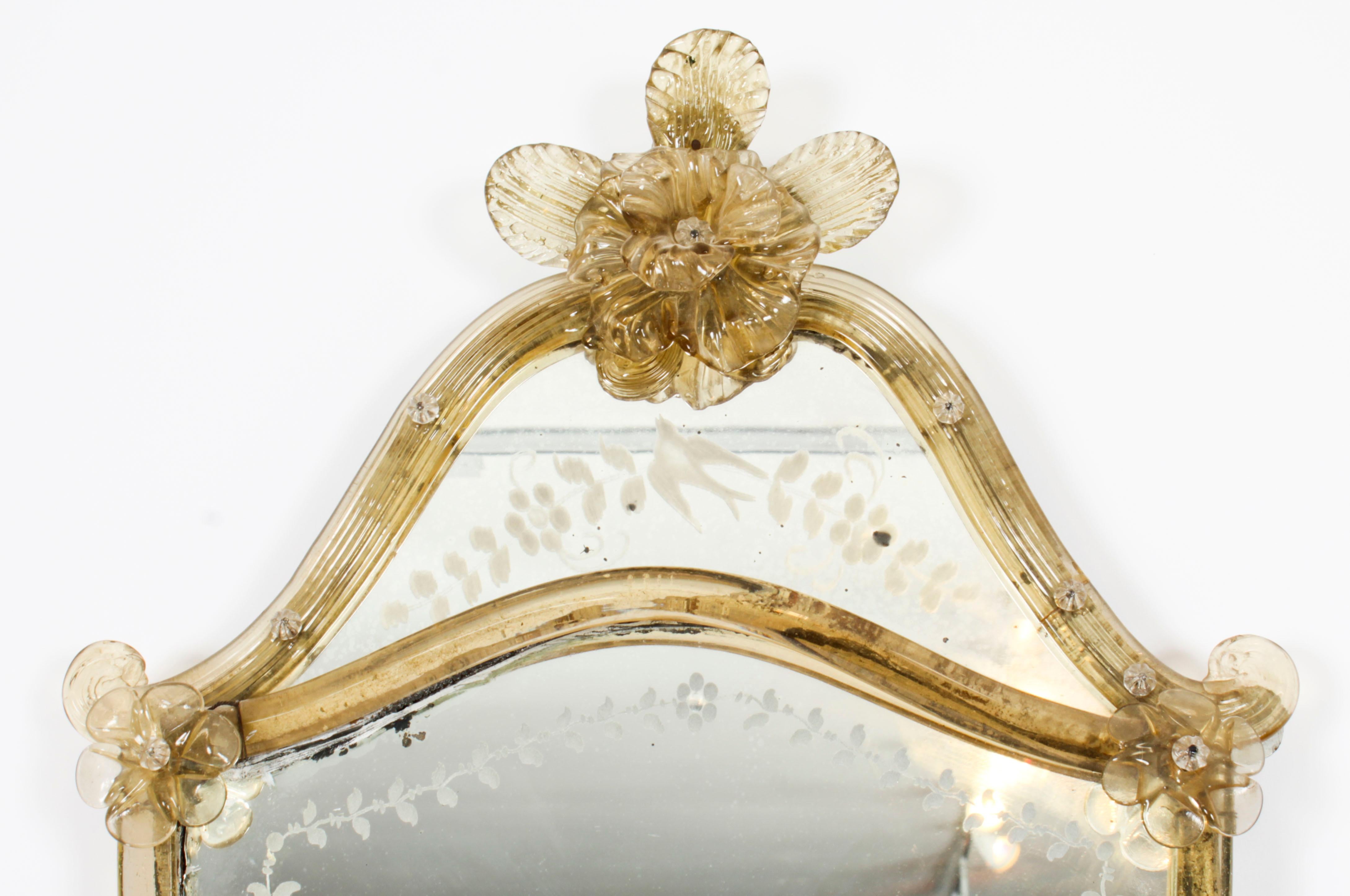 This is a delightful small Venetian glass etched mirror, circa 1880 in date.
 
This mirror has a large rose cartouche crest and is finely  shield shaped with  bead trim, rope styled borders, and flower-head accents. Wonderfully hand-etched with