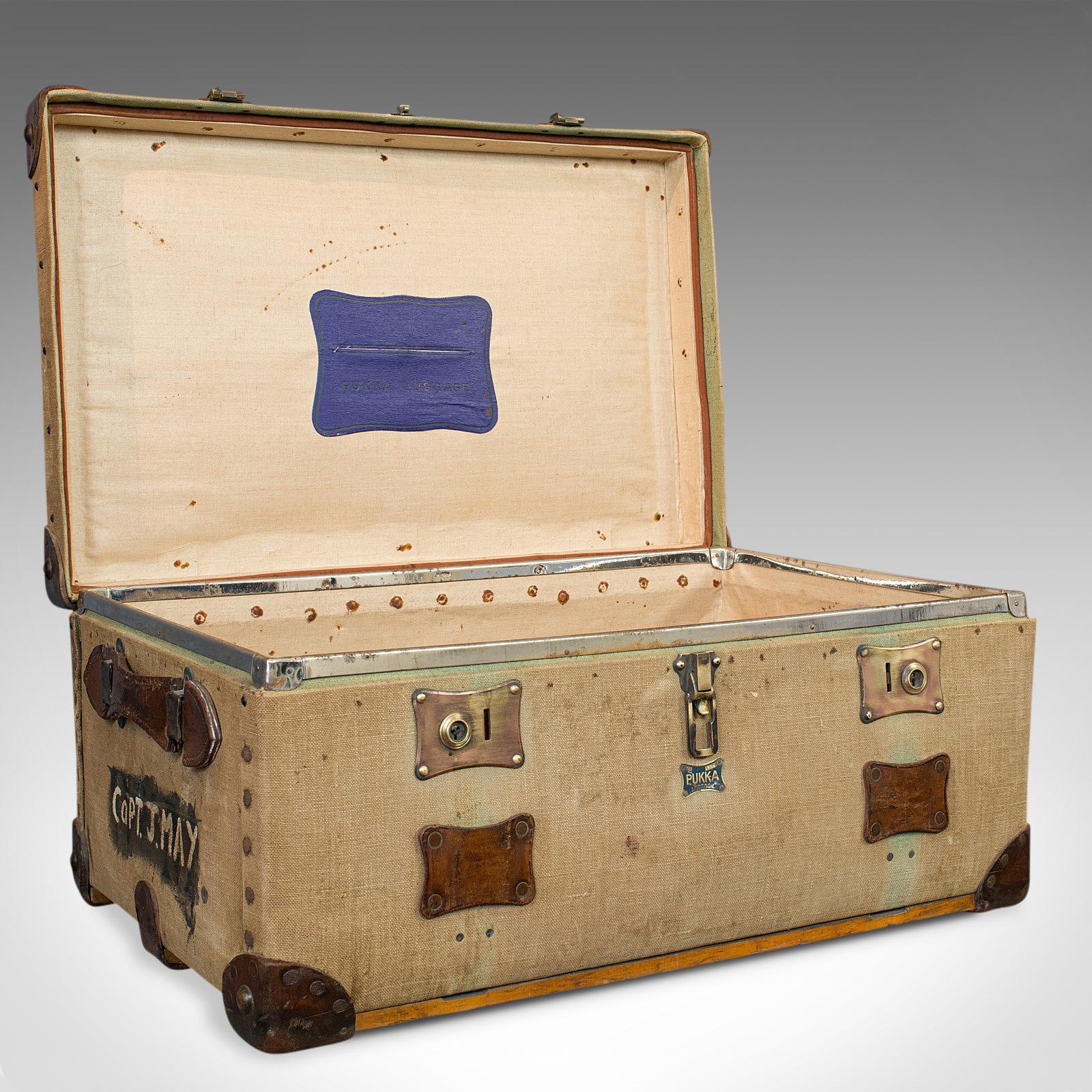 This is an antique shipping trunk. An English, canvas travel case by Pukka Luggage, dating to the Edwardian period, circa 1910.

Wonderful Edwardian style perfect for the grand tour
Displays a desirable aged patina
Quality canvas textile finish