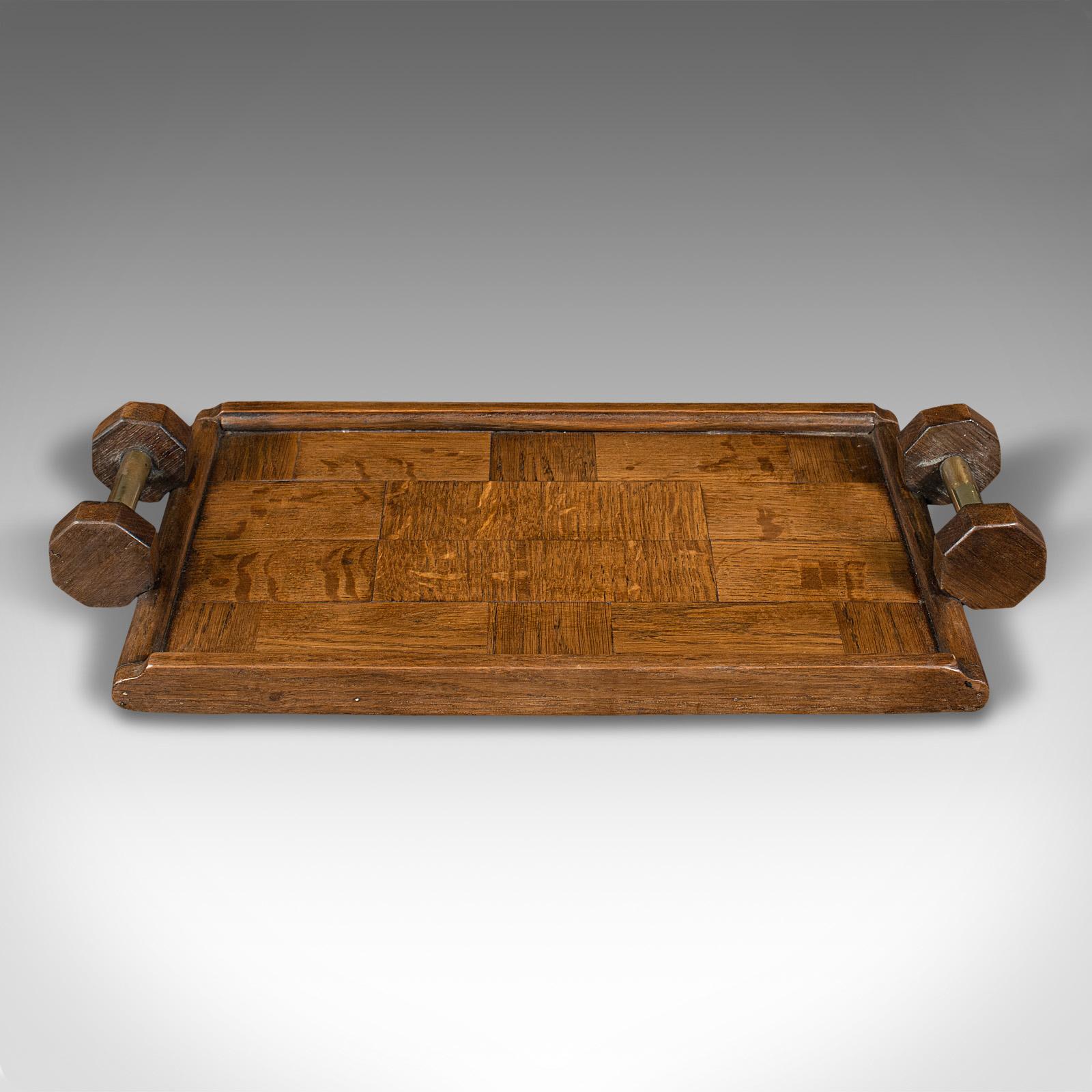 This is an antique ship's concierge tray. An English, oak maritime butler's slide, dating to the Edwardian period, circa 1910.

Distinctive form with appealing parquetry finish
Displaying a desirable aged patina and in good order
Select oak