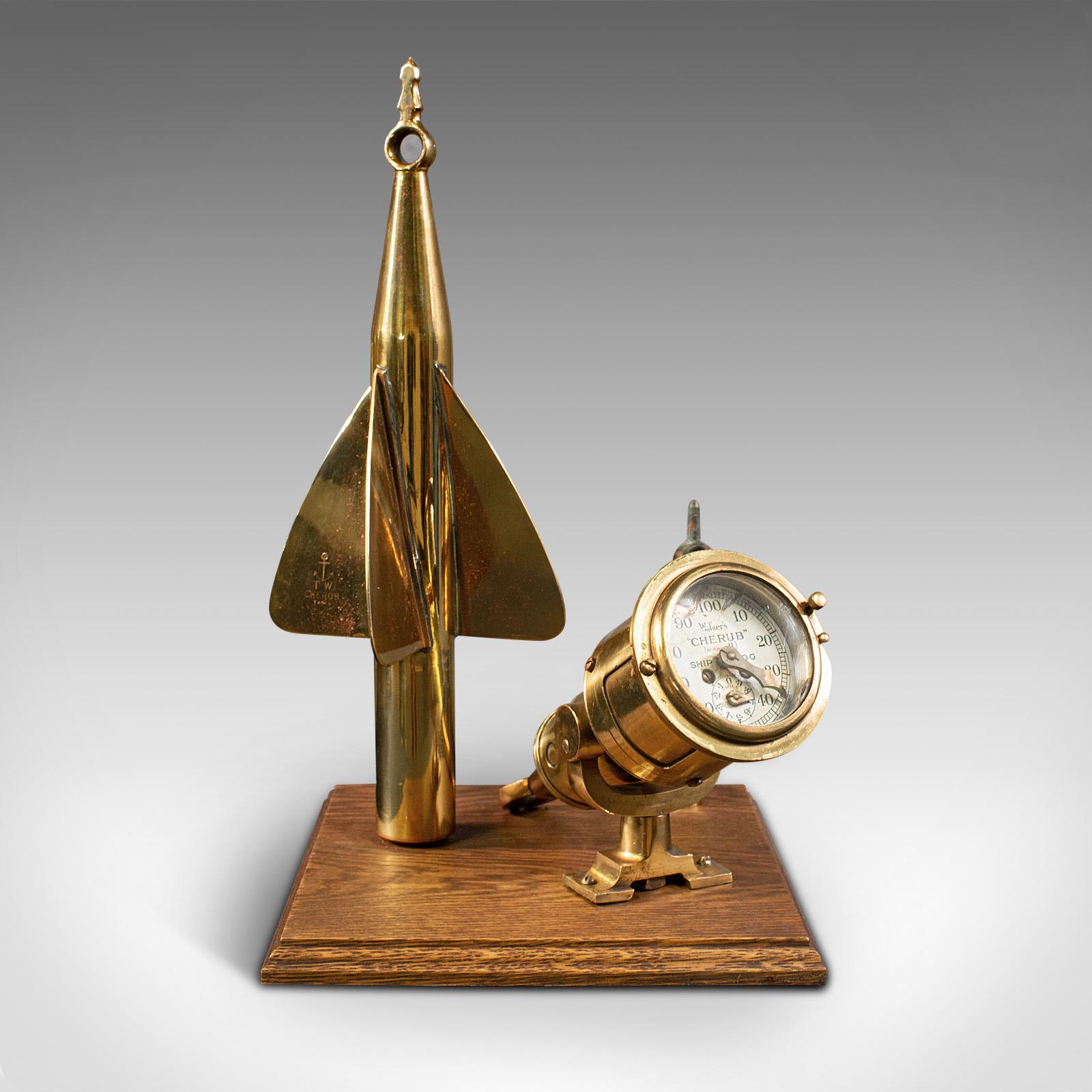This is an antique ship's log desk ornament. An English, brass and oak maritime display instrument, dating to the early 20th century, circa 1920.

Charming nautical interest, presented for display
Displaying a desirable aged patina and in good