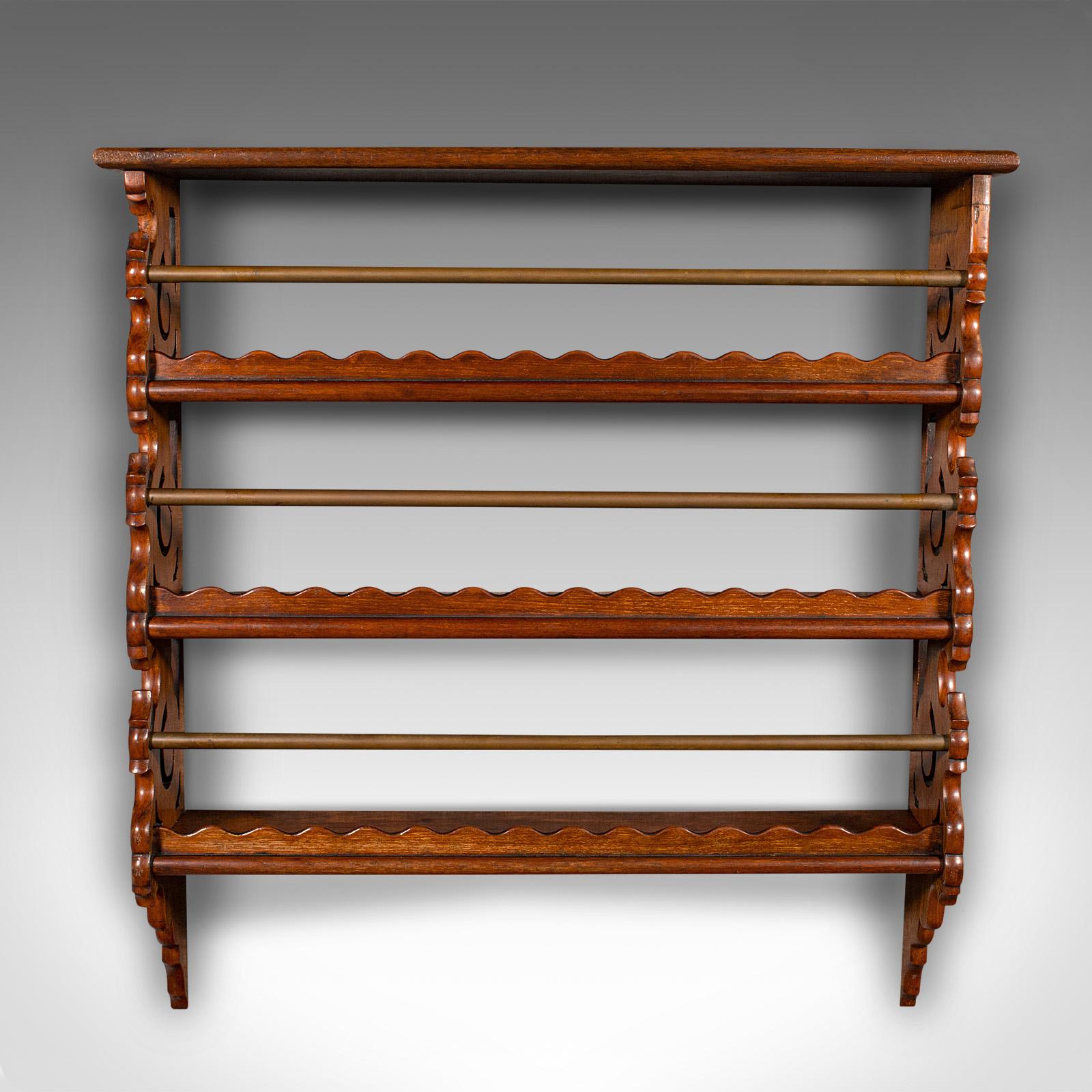 This is a set of antique ship's gallery shelves. An English, mahogany and brass maritime or kitchen rack with safety bars, dating to the Edwardian period, circa 1910.

Attractive shelf unit with carved and pierced detail
Displaying a desirable