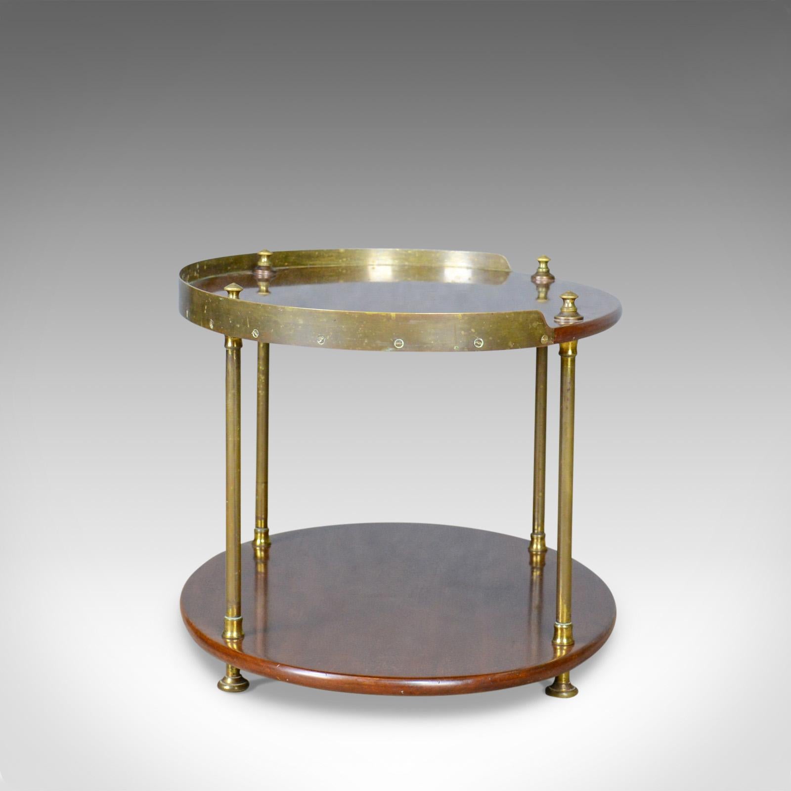 This is an antique ship's table, an English, solid mahogany and brass, two-tier side table dating to the Edwardian period of the early 20th century, circa 1910.

Beautifully crafted in select mahogany and turned brass.
Attractive rich, dark tones