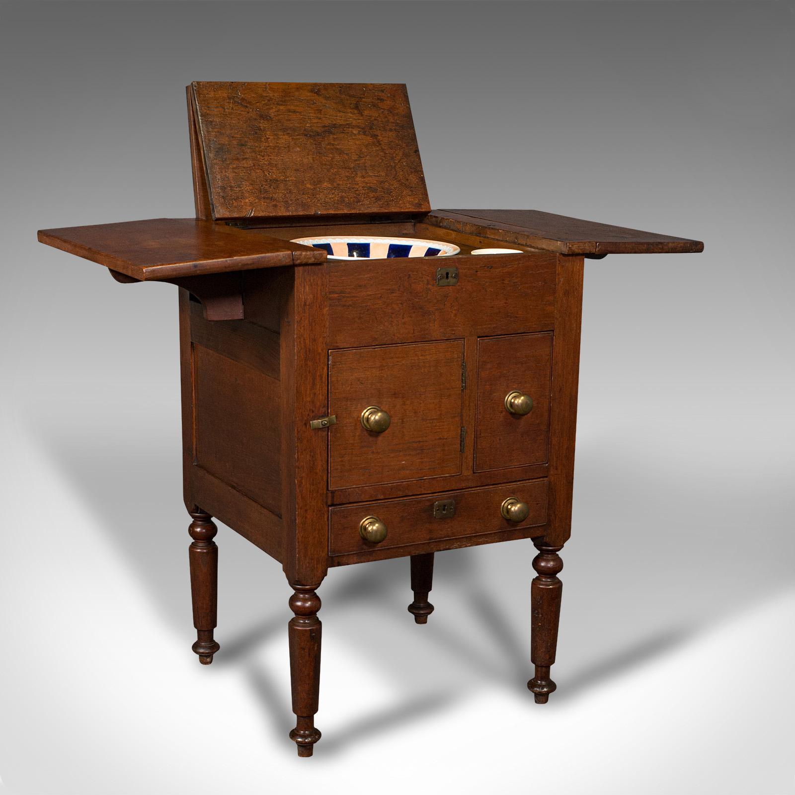 This is an antique ship's wash stand. An English, mahogany drop flap nightstand, dating to the early Victorian period, circa 1850.

Fascinating example of maritime furniture
Displays a desirable aged patina with original marks commensurate with